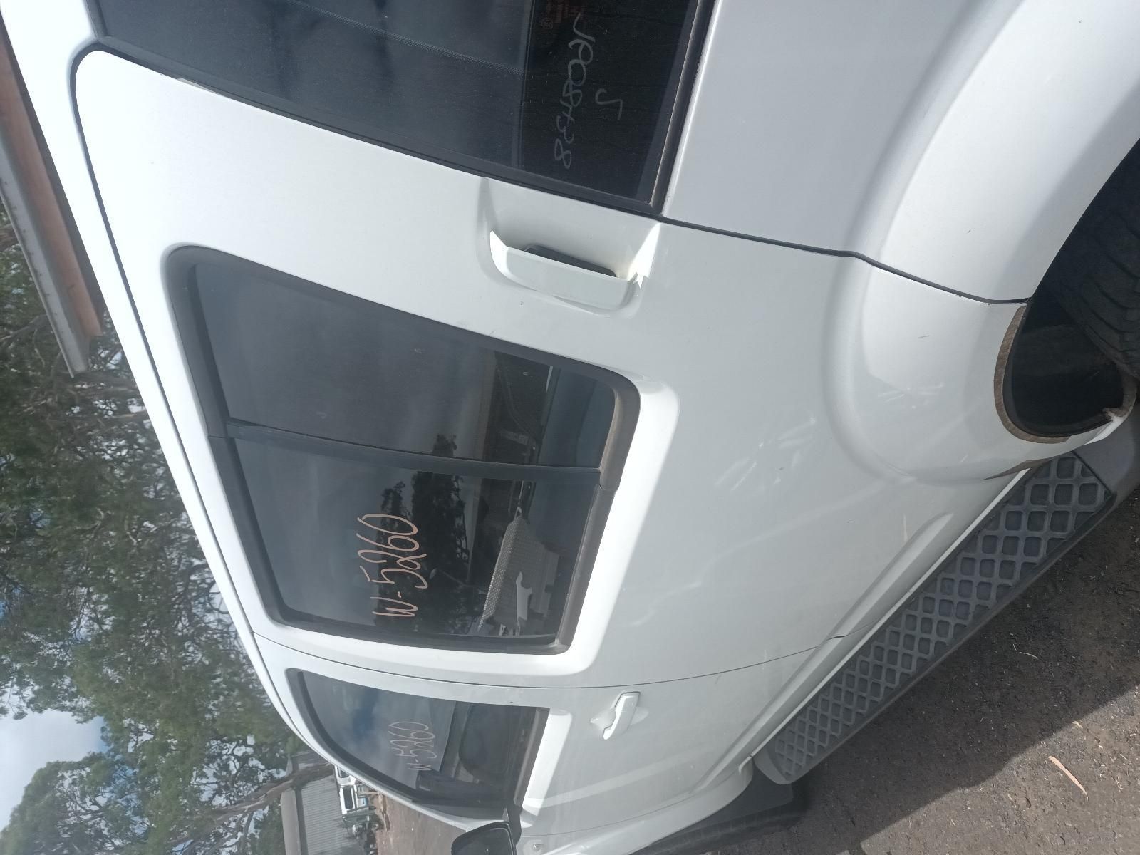 A White Car is Parked on the Side of the Road — South West 4WD Wreckers In Brisbane, QLD