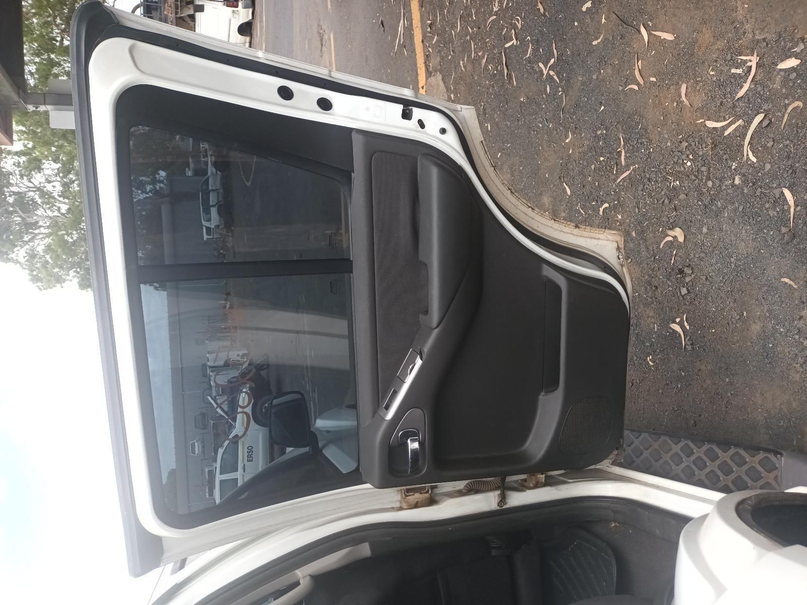 A White Car with the Door Open is Parked on the Side of the Road — South West 4WD Wreckers In Brisbane, QLD