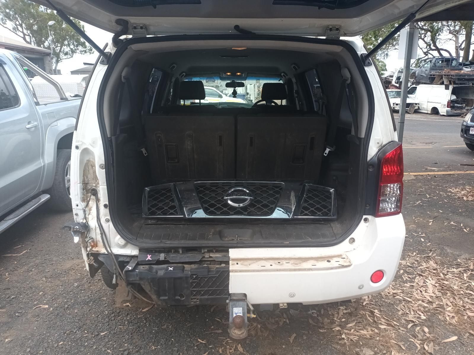 A White SUV with the Trunk Open is Parked in a Parking Lot — South West 4WD Wreckers In Brisbane, QLD