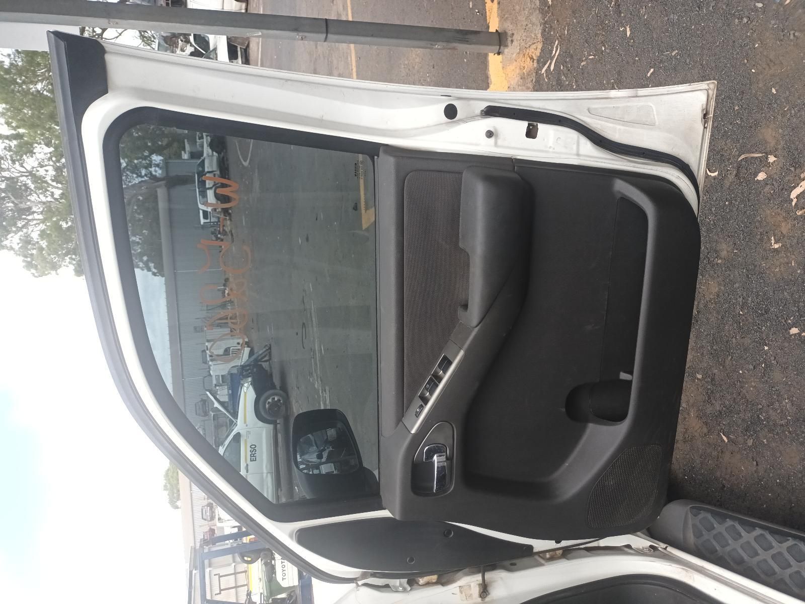 A White Car with the Door Open is Parked on the Side of the Road — South West 4WD Wreckers In Brisbane, QLD