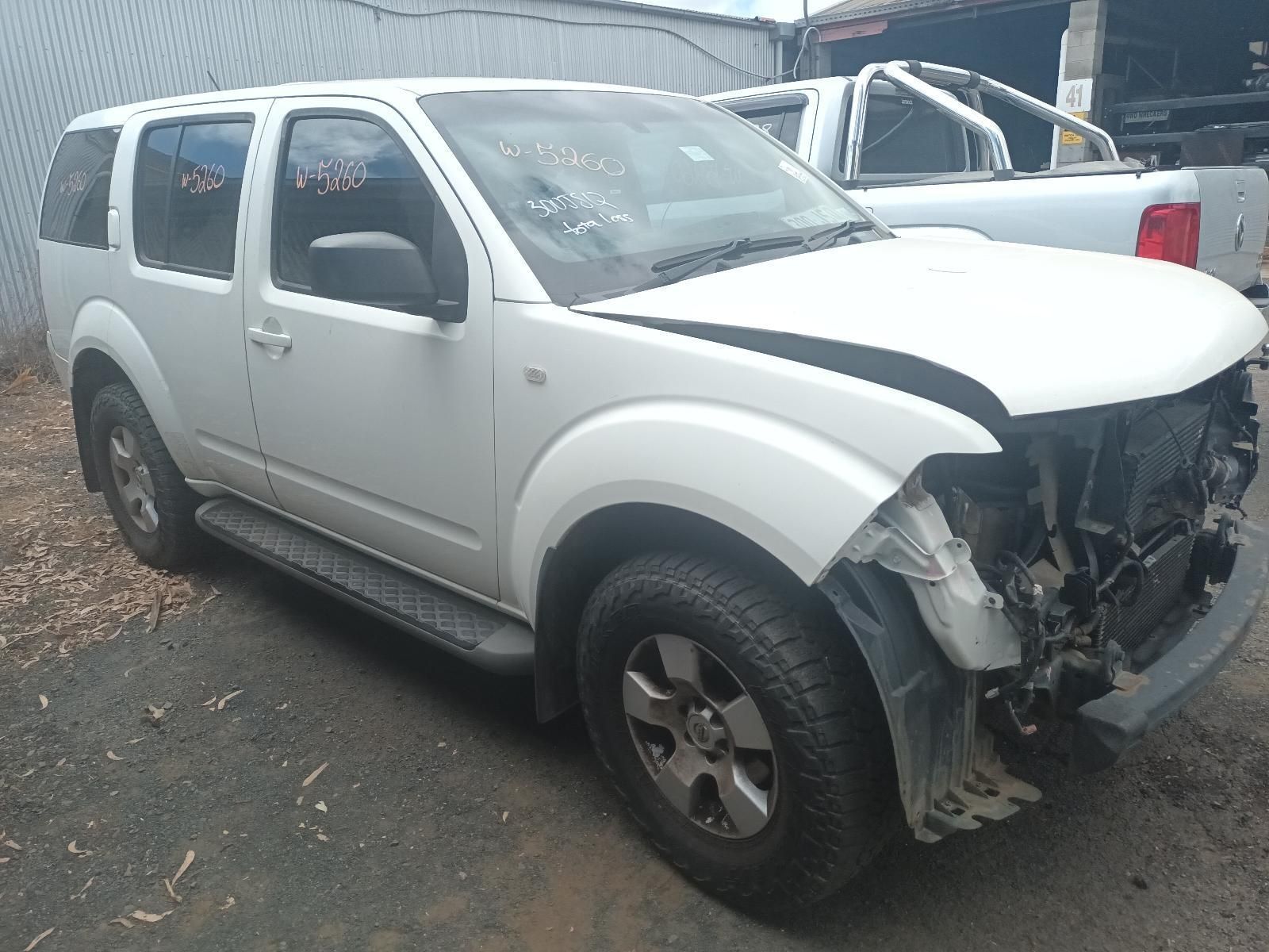 A White Nissan Pathfinder with a Damaged Hood is Parked in a Parking Lot — South West 4WD Wreckers In Brisbane, QLD