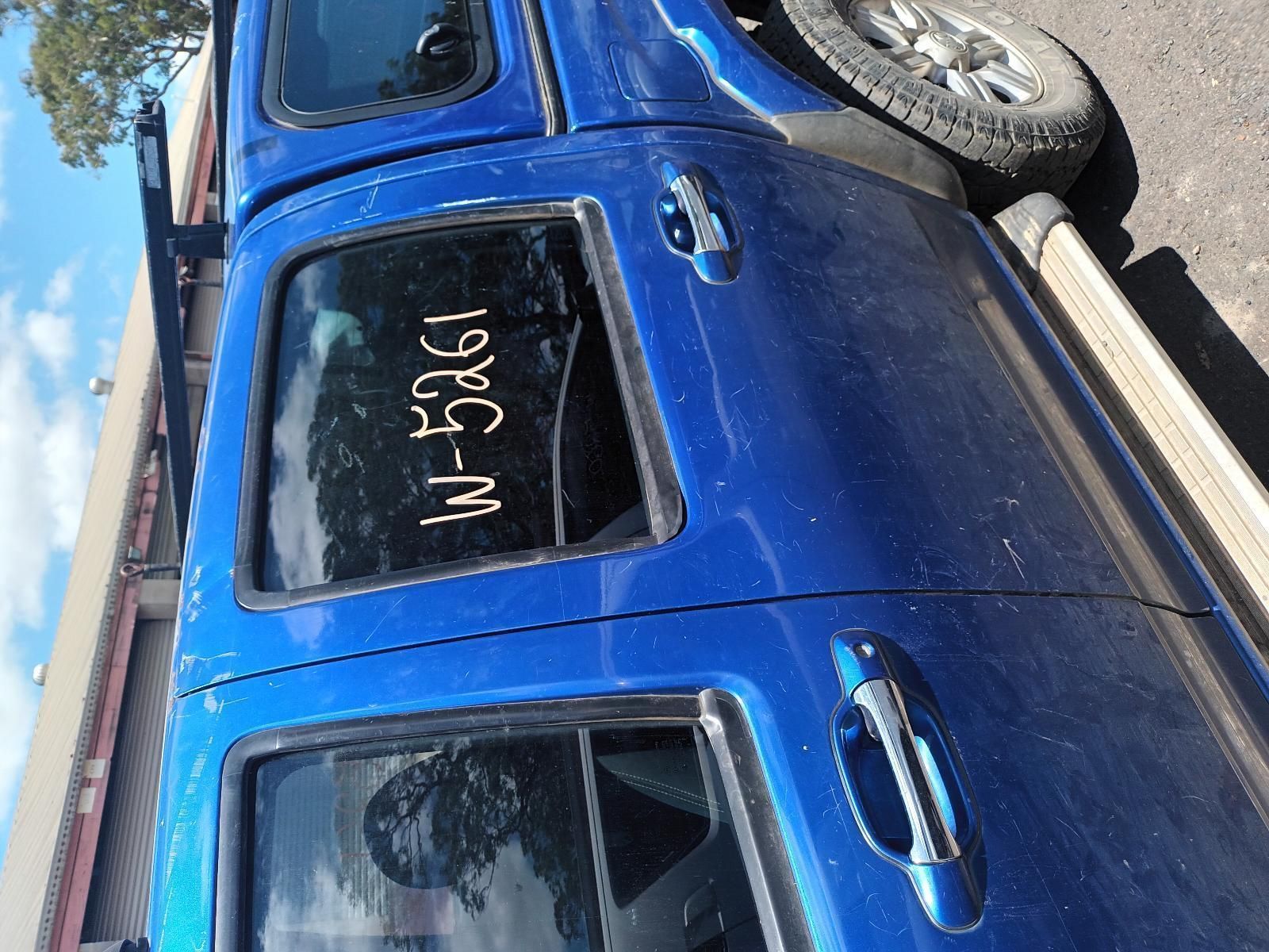 A Blue Truck is Parked on the Side of the Road — South West 4WD Wreckers In Brisbane, QLD