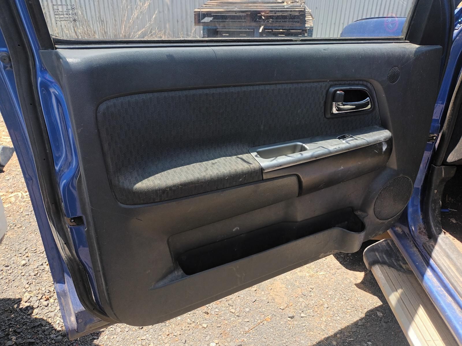 A Blue Car with the Door Open is Parked on the Side of the Road — South West 4WD Wreckers In Brisbane, QLD
