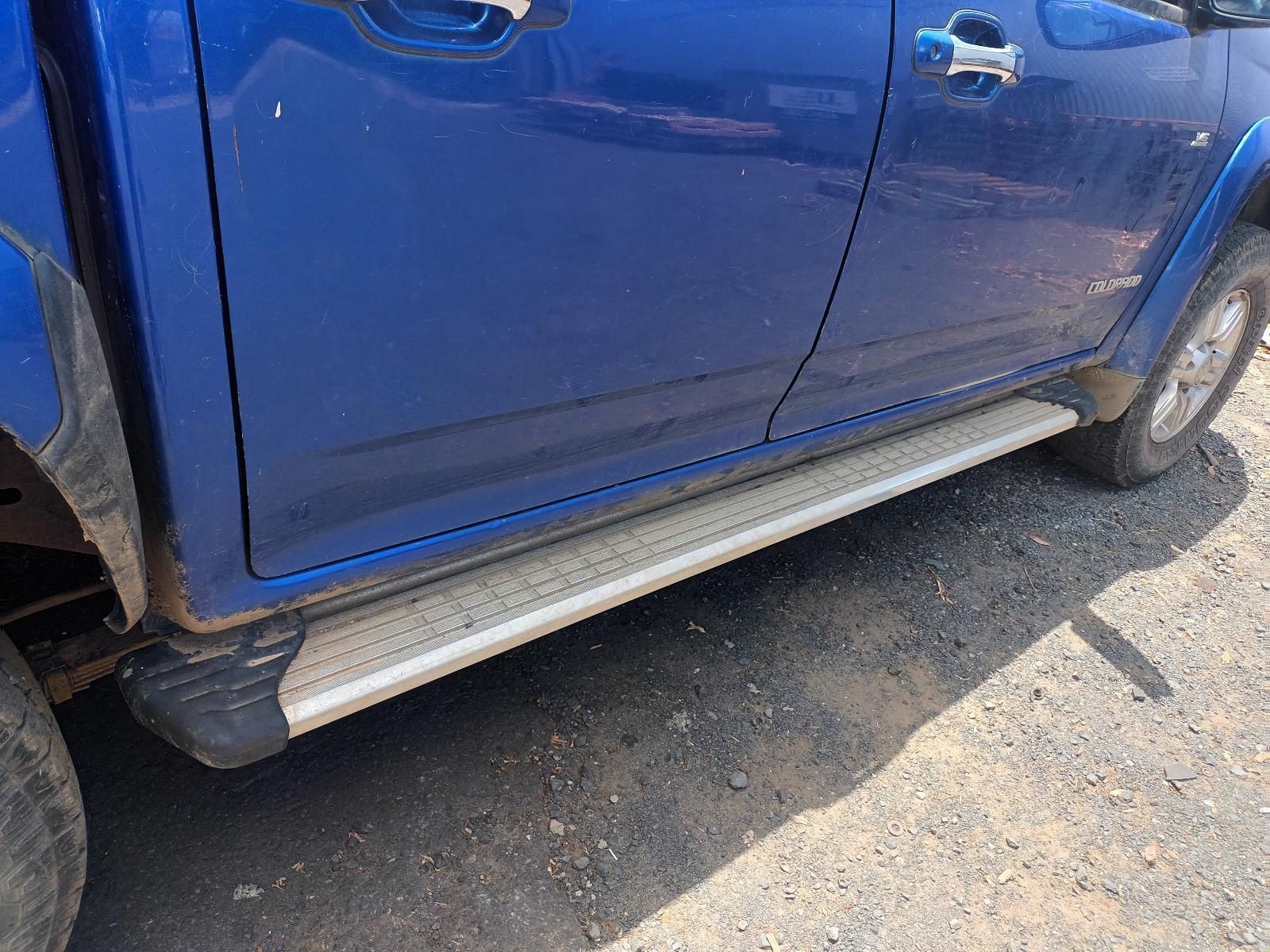 A Blue Truck with Side Steps is Parked on a Dirt Road — South West 4WD Wreckers In Brisbane, QLD
