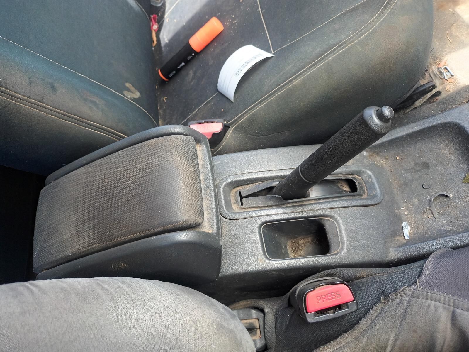 A Dirty Car Console with a Red Button on the Side — South West 4WD Wreckers In Brisbane, QLD