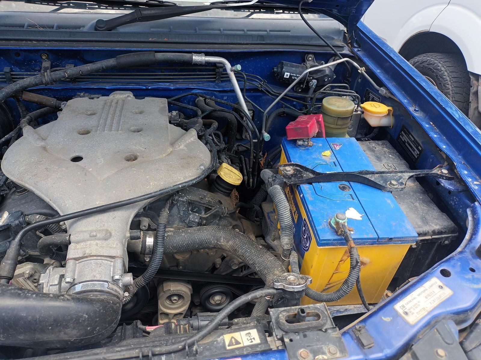 A Blue Car with a Yellow Battery Under the Hood — South West 4WD Wreckers In Brisbane, QLD