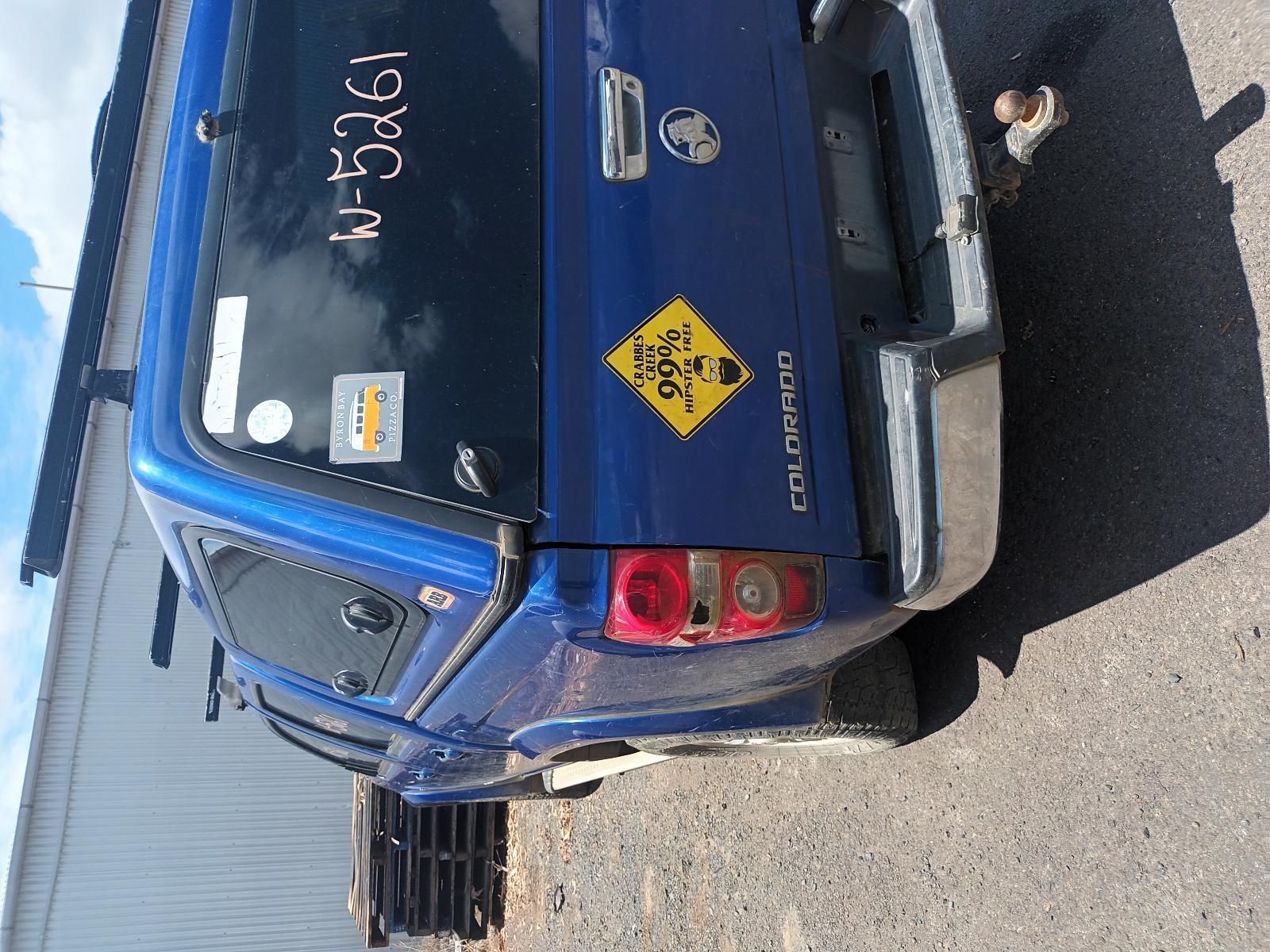 The Back of a Blue Truck with a Yellow Sign on It — South West 4WD Wreckers In Brisbane, QLD