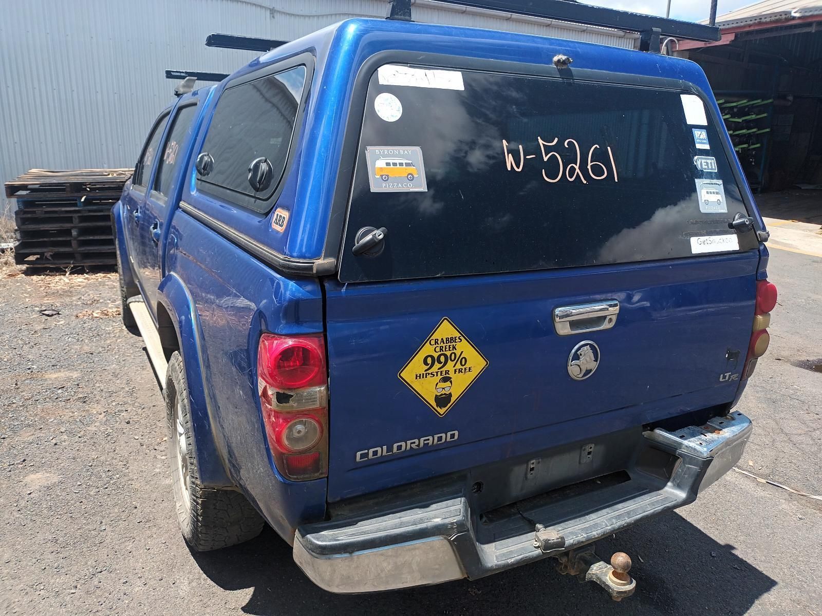 A Blue Truck with a Yellow Sign on the Back of It — South West 4WD Wreckers In Brisbane, QLD