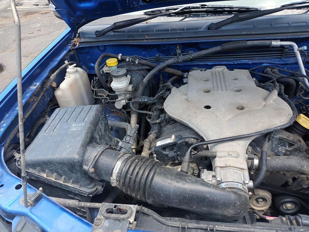 The Engine of a Blue Car is Shown with the Hood Open — South West 4WD Wreckers In Brisbane, QLD