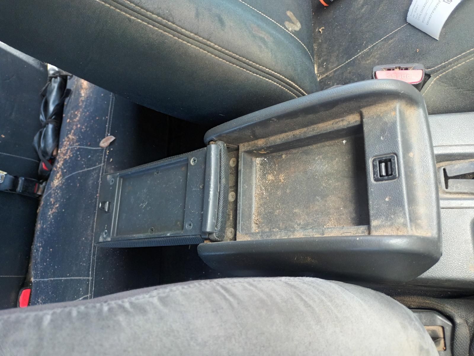 A Dirty Arm Rest in a Car with a Button on It — South West 4WD Wreckers In Brisbane, QLD