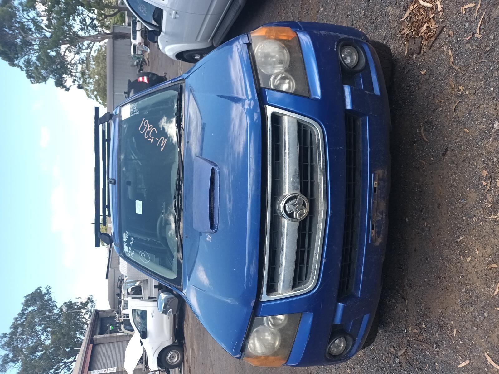 A Blue Car is Parked in a Parking Lot with Other Cars — South West 4WD Wreckers In Brisbane, QLD
