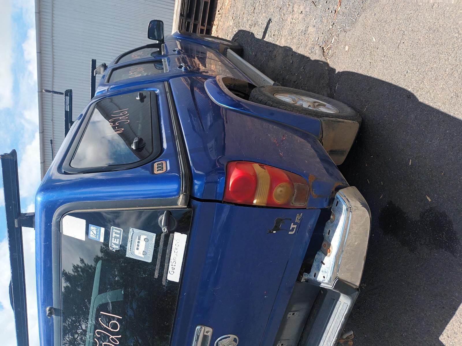 A Blue Truck is Parked on the Side of the Road — South West 4WD Wreckers In Brisbane, QLD