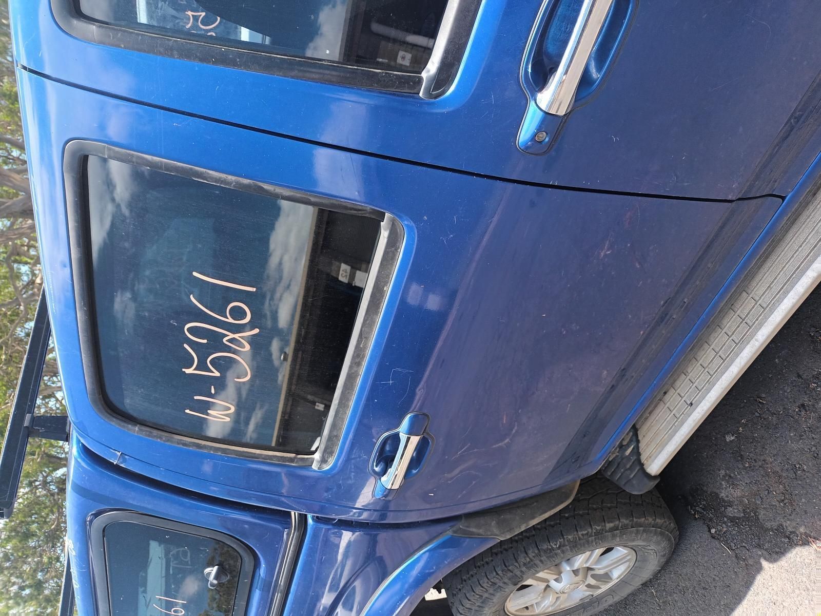 A Blue Truck is Parked on the Side of the Road — South West 4WD Wreckers In Brisbane, QLD