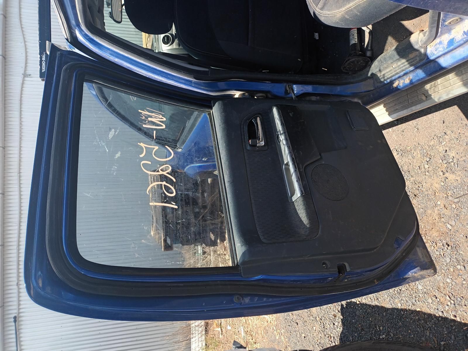 A Blue Car with the Door Open is Parked on the Side of the Road — South West 4WD Wreckers In Brisbane, QLD