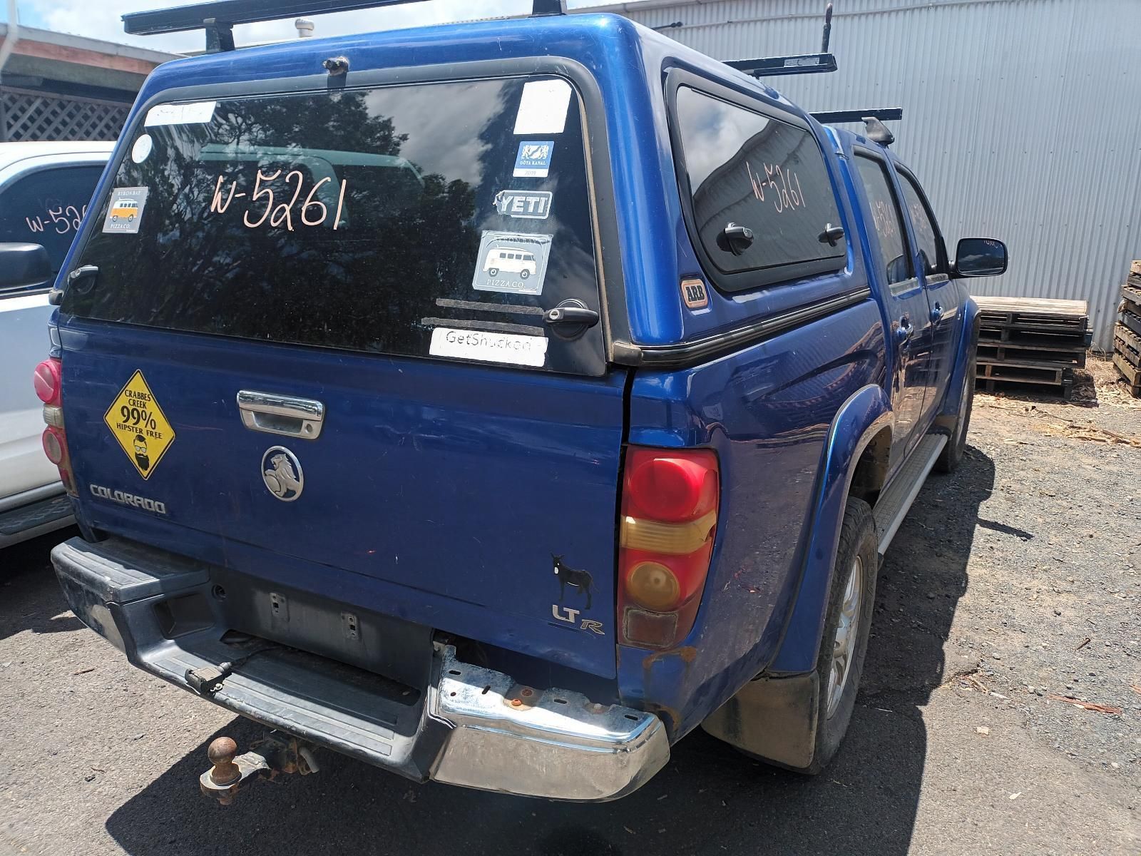 A Blue Truck with a Canopy is Parked in a Parking Lot — South West 4WD Wreckers In Brisbane, QLD