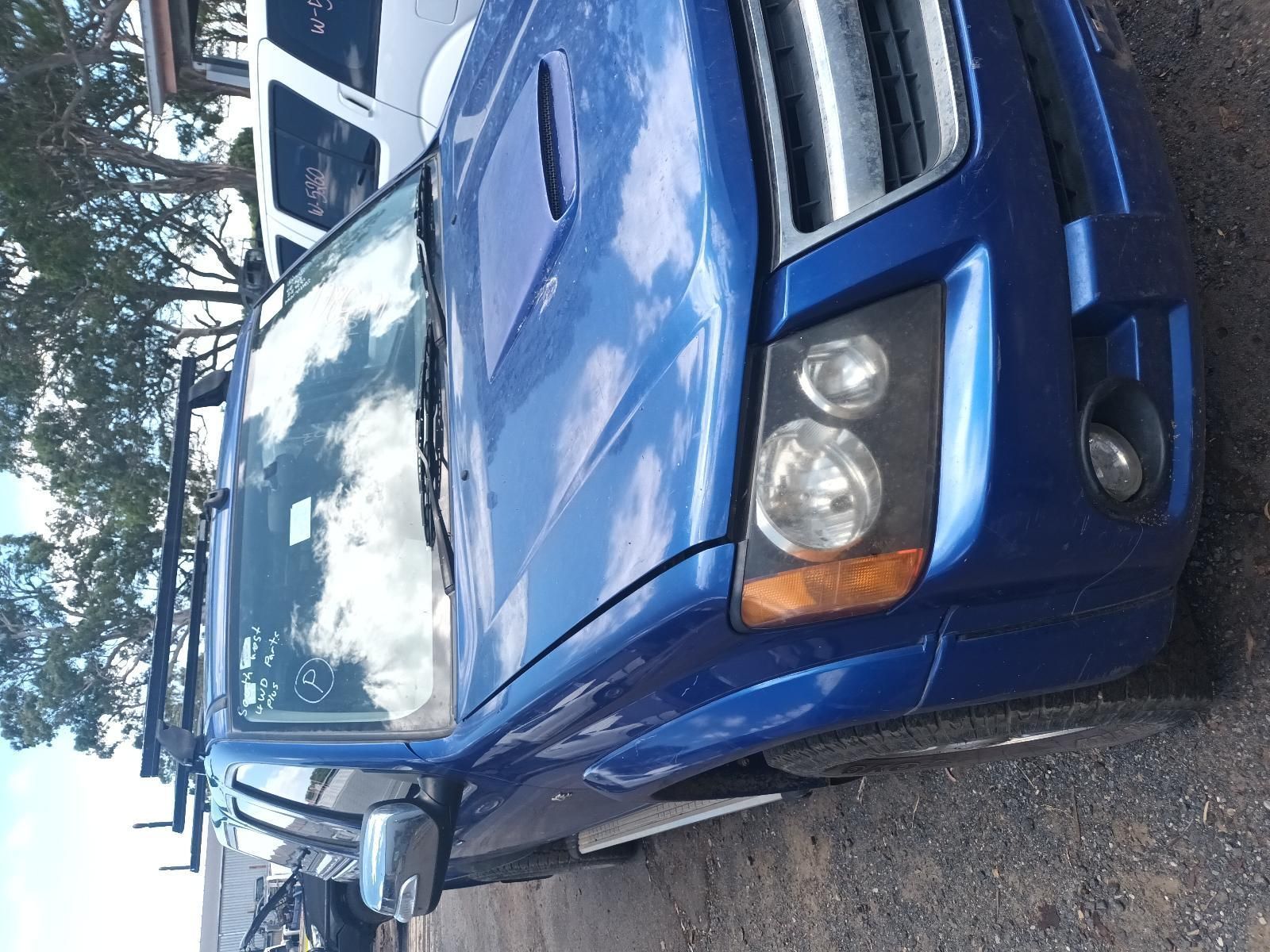 A Blue Truck is Parked on the Side of the Road — South West 4WD Wreckers In Brisbane, QLD