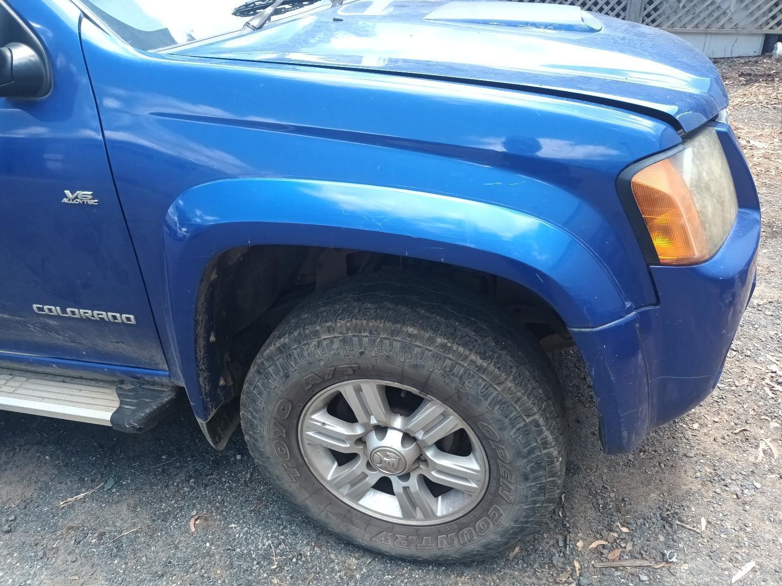 A Blue Truck is Parked on the Side of the Road — South West 4WD Wreckers In Brisbane, QLD