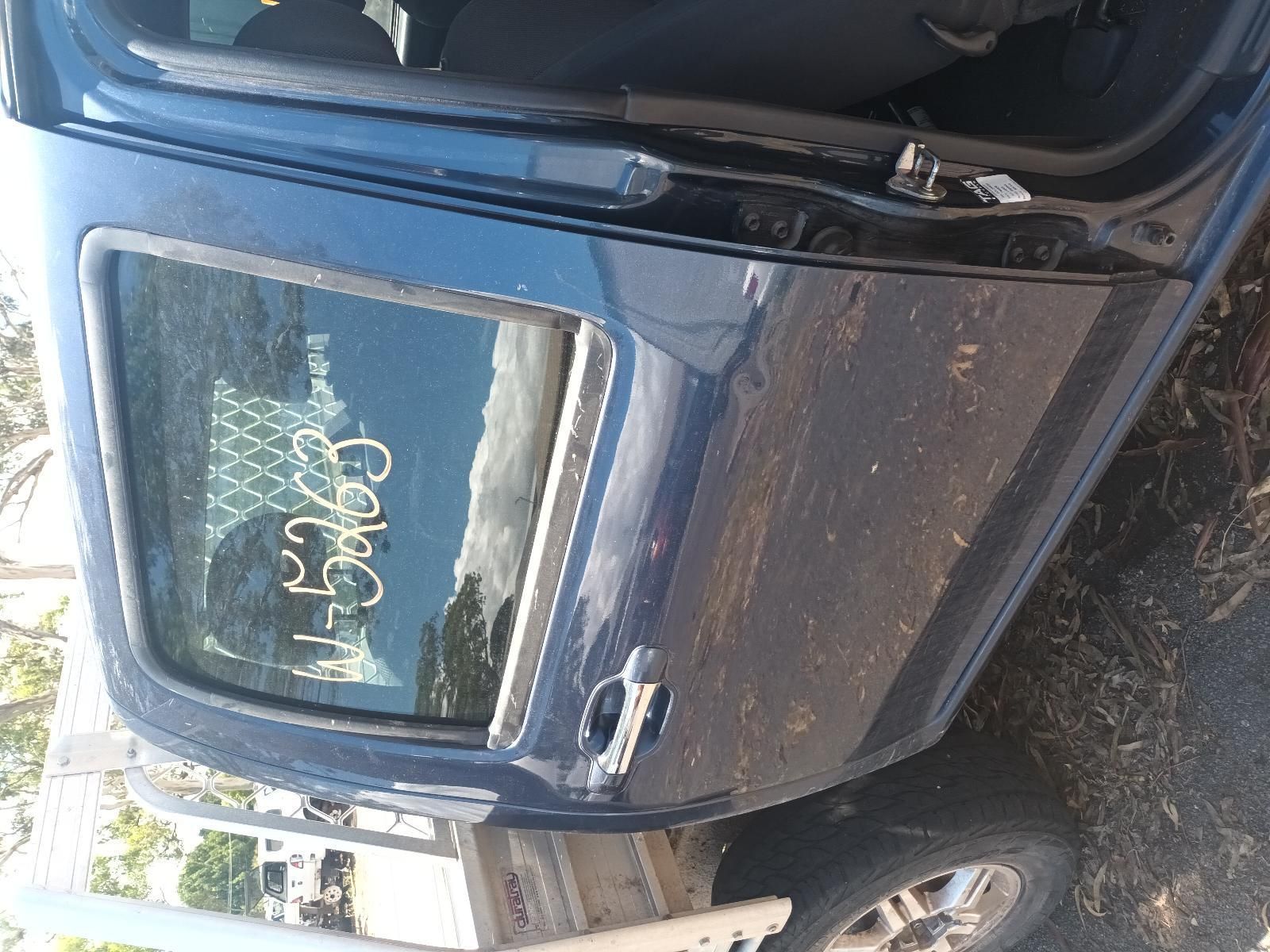 A Blue Car with the Door Open is Sitting on the Ground — South West 4WD Wreckers in Harristown, QLD