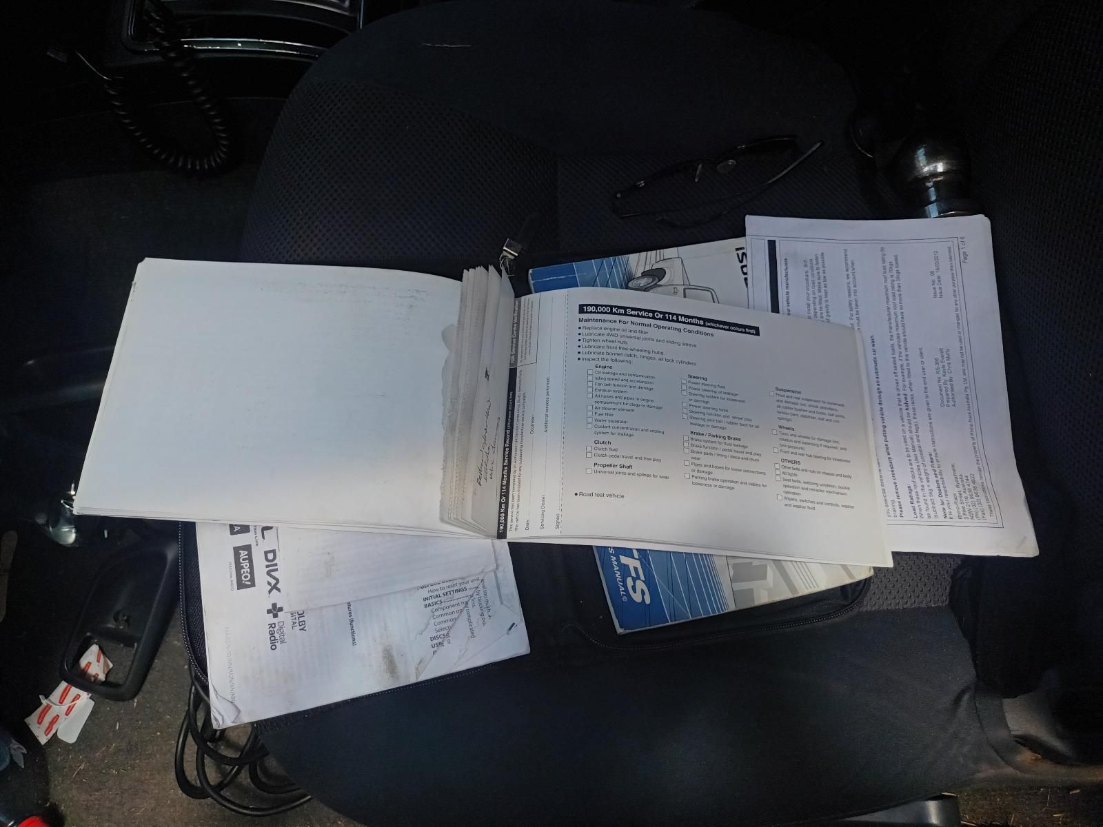 A Bunch of Papers Are Laying on the Seat of a Car — South West 4WD Wreckers in Harristown, QLD