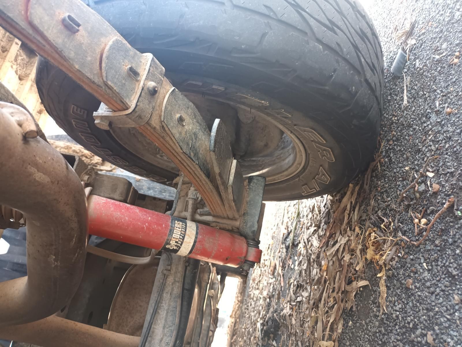 A Close Up of a Tire on a Vehicle with a Leaf Spring Attached to It — South West 4WD Wreckers in Harristown, QLD
