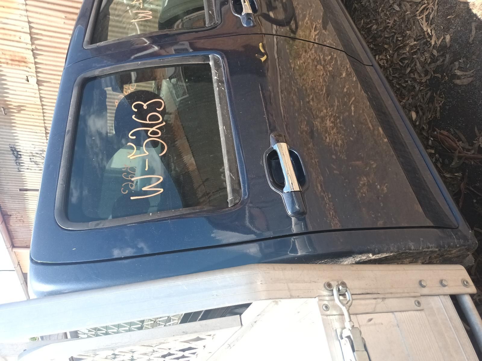 A Blue Truck is Sitting on the Ground with the Door Open — South West 4WD Wreckers in Harristown, QLD