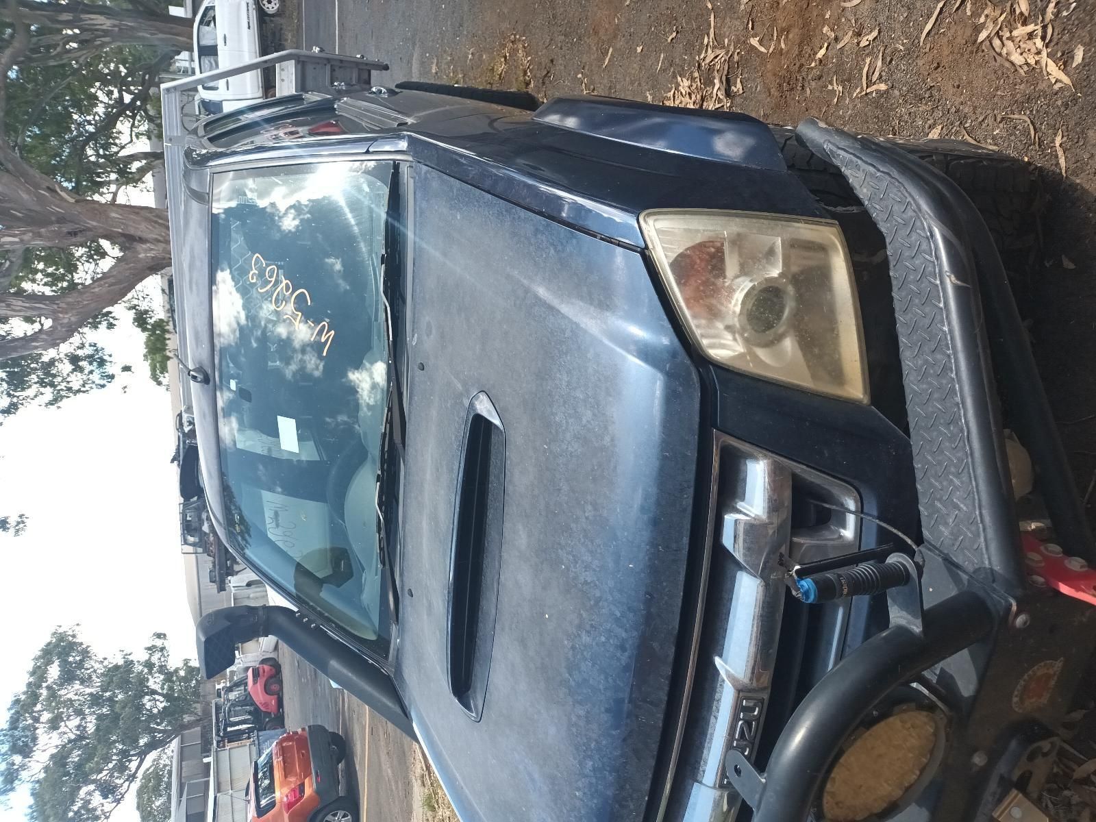 A Blue Truck is Parked on the Side of the Road — South West 4WD Wreckers in Harristown, QLD