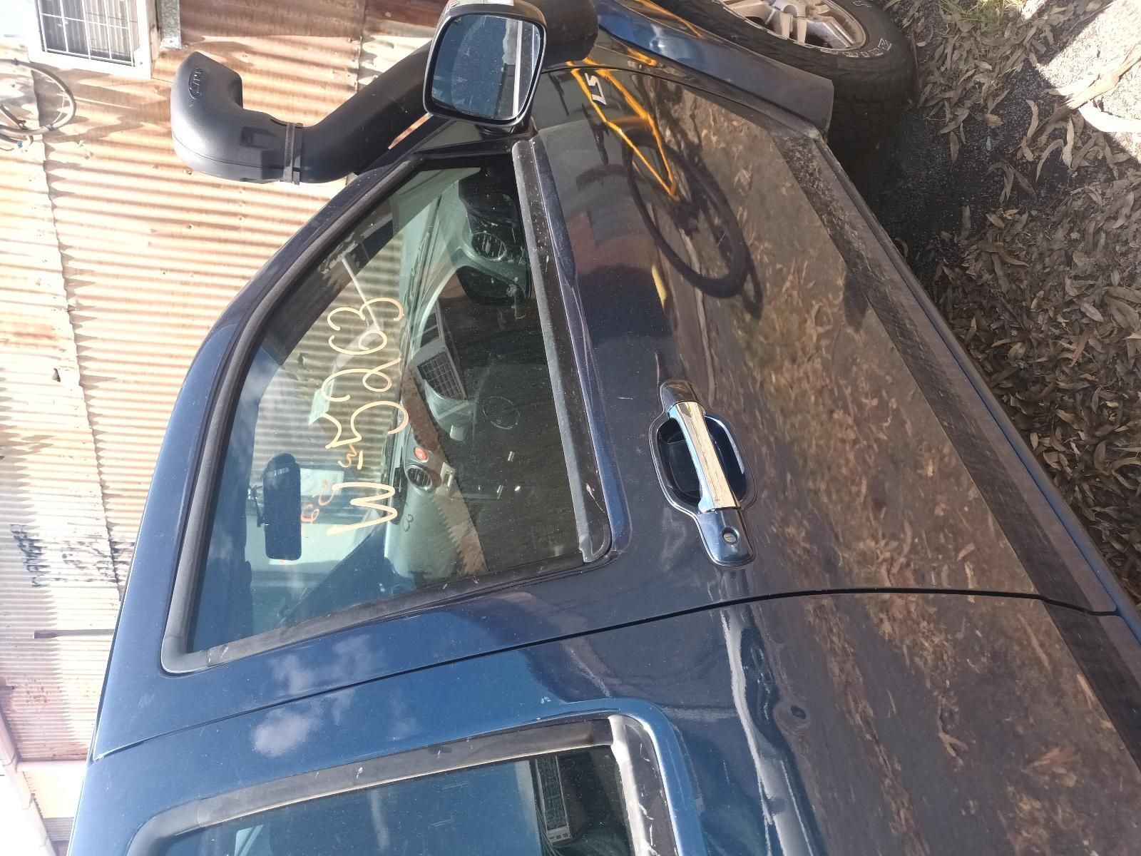 A Blue Truck is Parked on the Side of the Road — South West 4WD Wreckers in Harristown, QLD