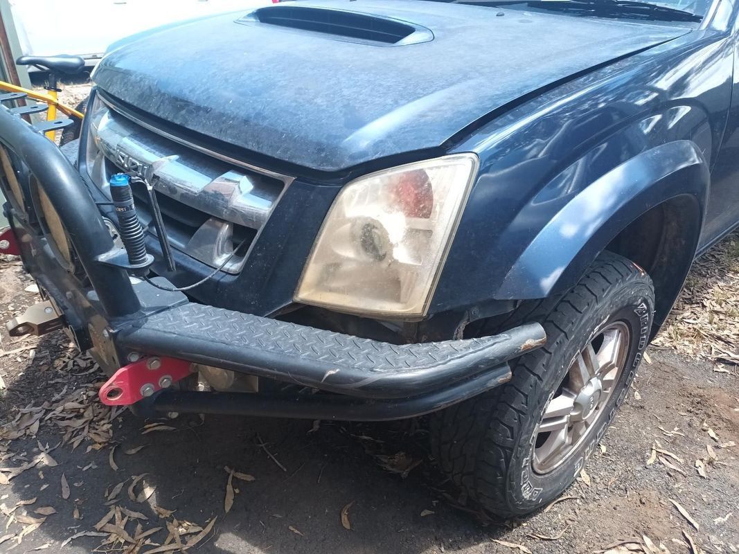 A Blue Truck with a Bumper on It is Parked in the Dirt — South West 4WD Wreckers in Harristown, QLD