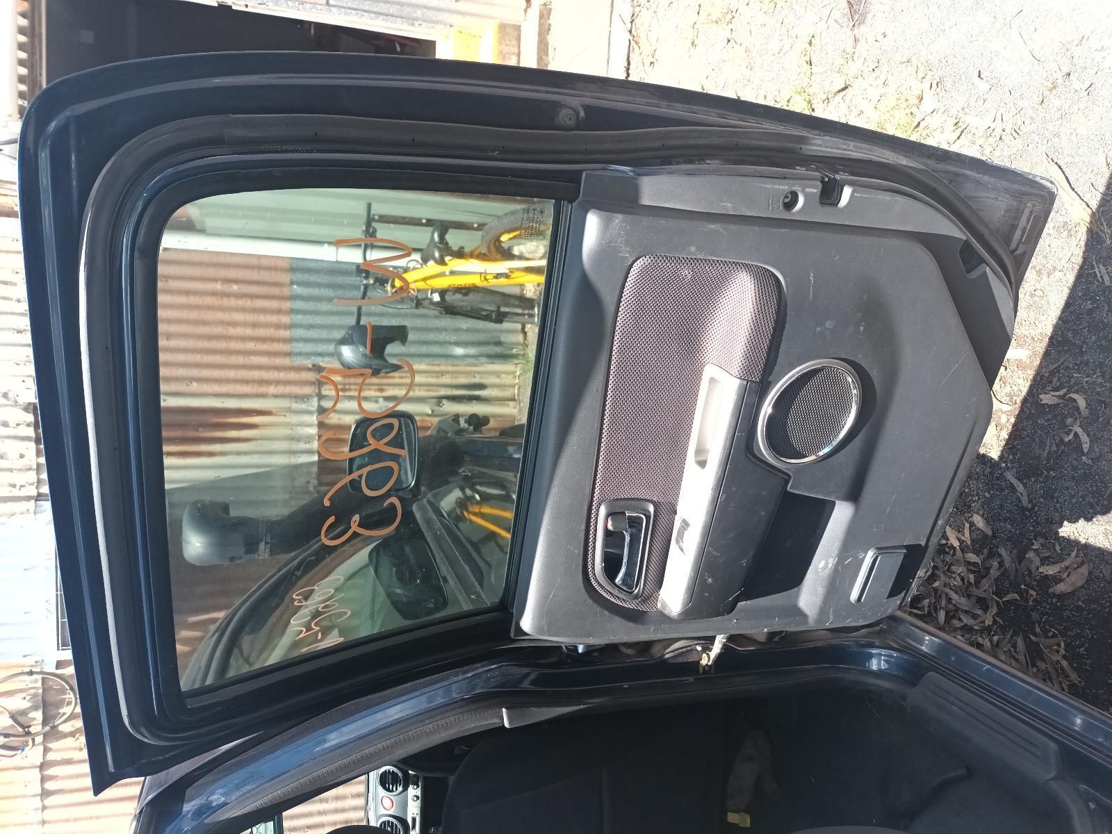 A Black Car with the Door Open and a Bicycle in the Background — South West 4WD Wreckers in Harristown, QLD