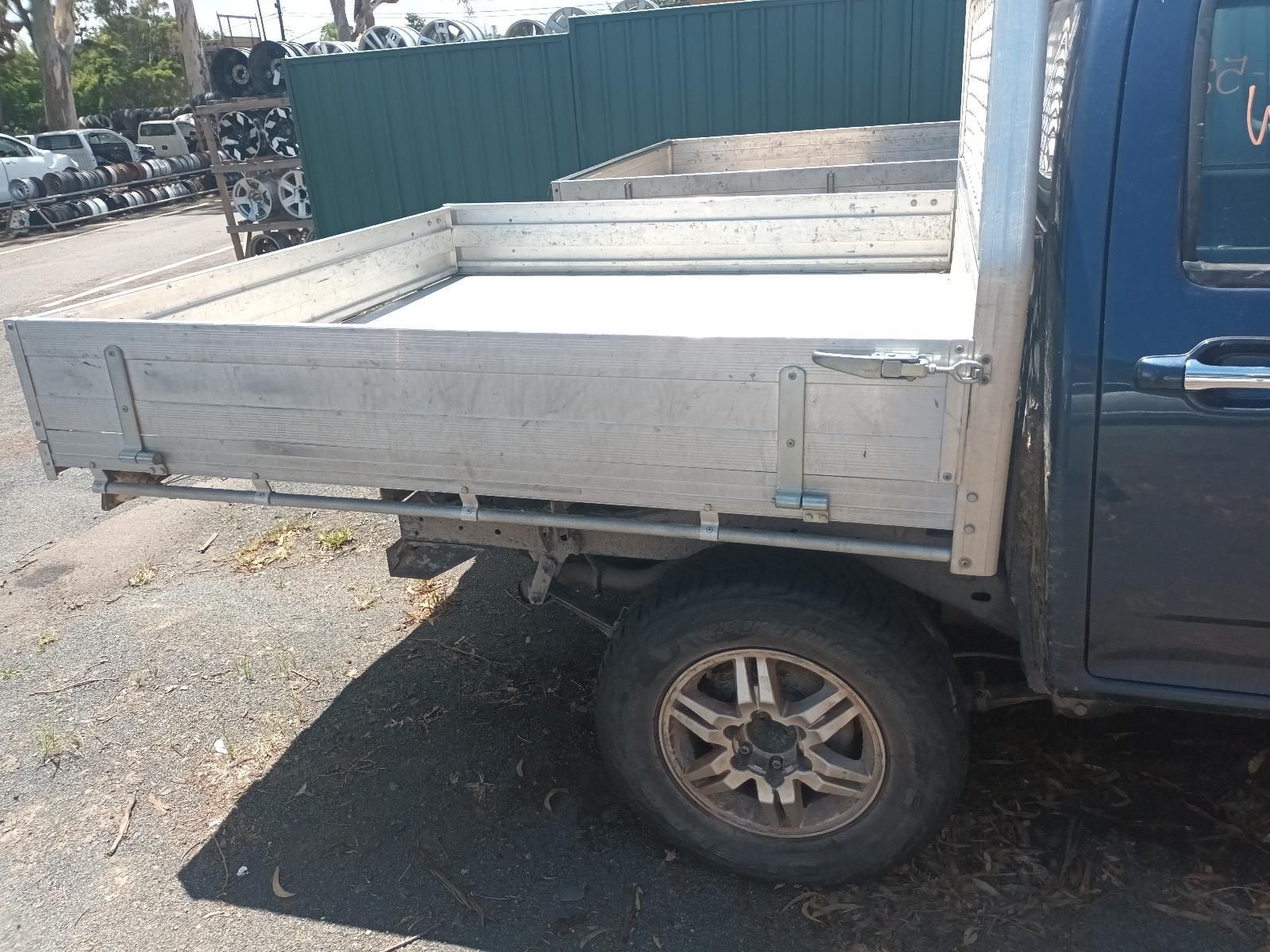 A Blue Truck with a Tray on the Back is Parked in a Parking Lot — South West 4WD Wreckers in Harristown, QLD