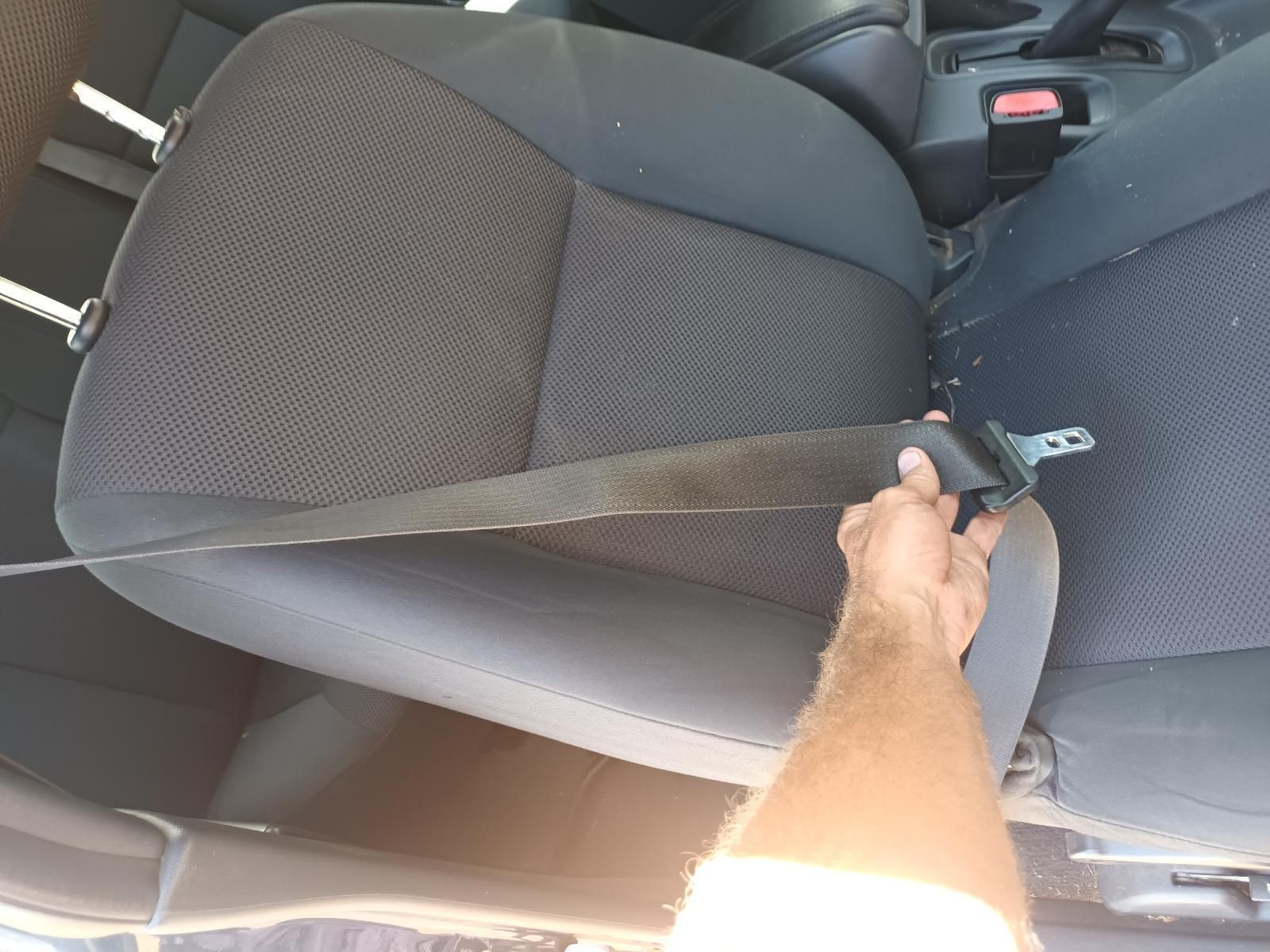 A Person is Putting on a Seat Belt in a Car — South West 4WD Wreckers in Harristown, QLD