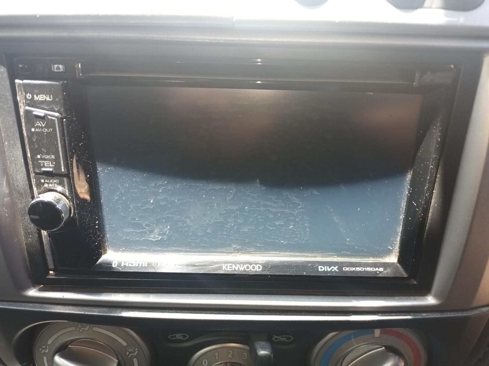A Car Radio with a Black Screen is Sitting on the Dashboard of a Car — South West 4WD Wreckers in Harristown, QLD