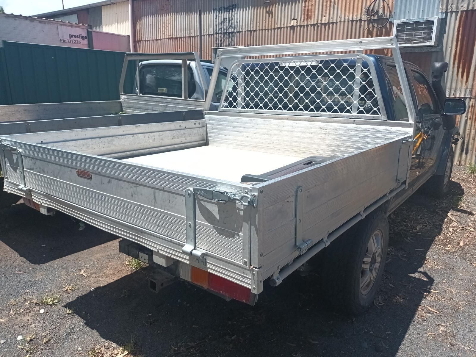 A Silver Truck with a Tray on the Back is Parked in a Parking Lot — South West 4WD Wreckers in Harristown, QLD