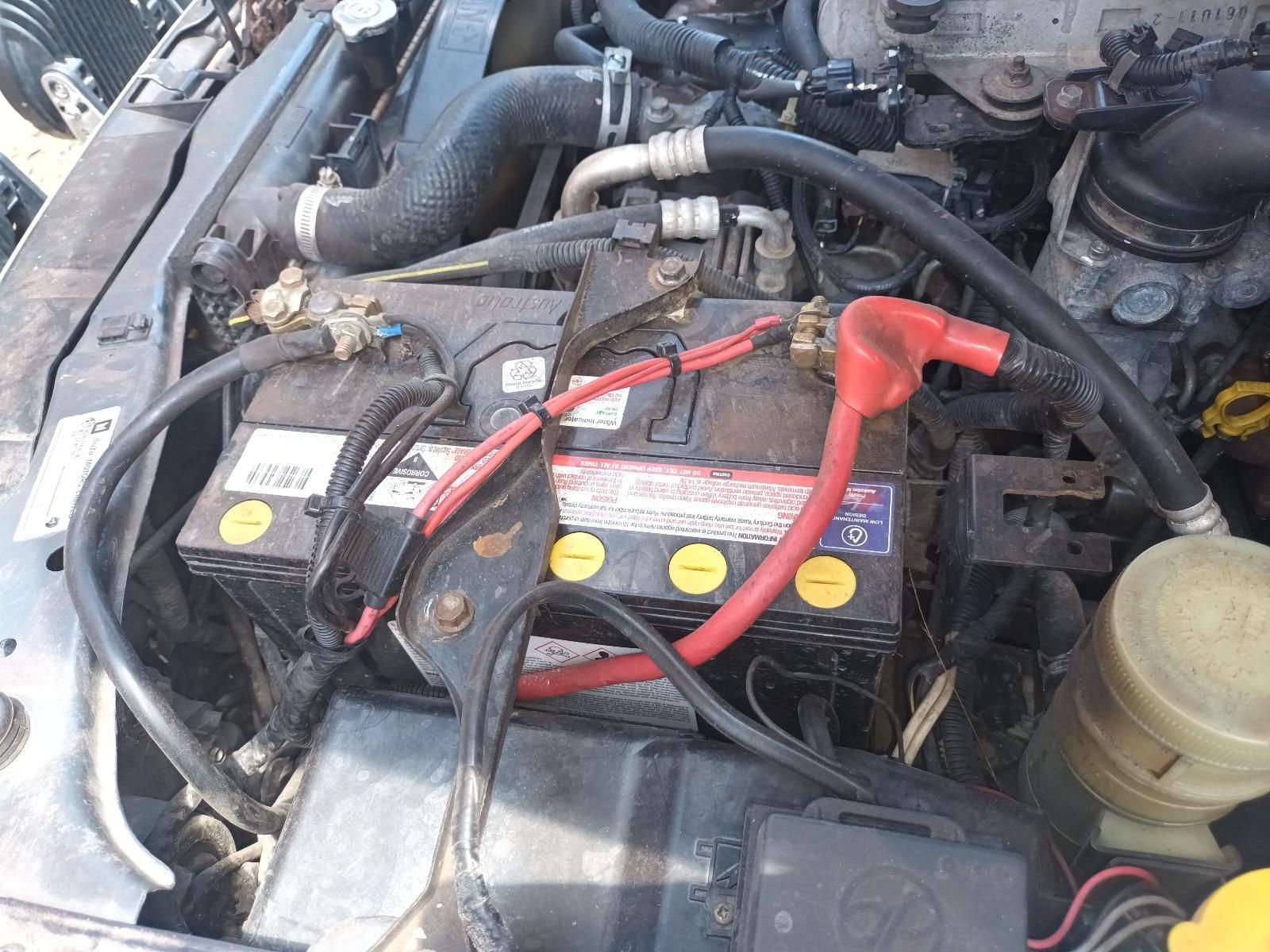 A Close Up of a Car Engine with a Battery in It — South West 4WD Wreckers in Harristown, QLD