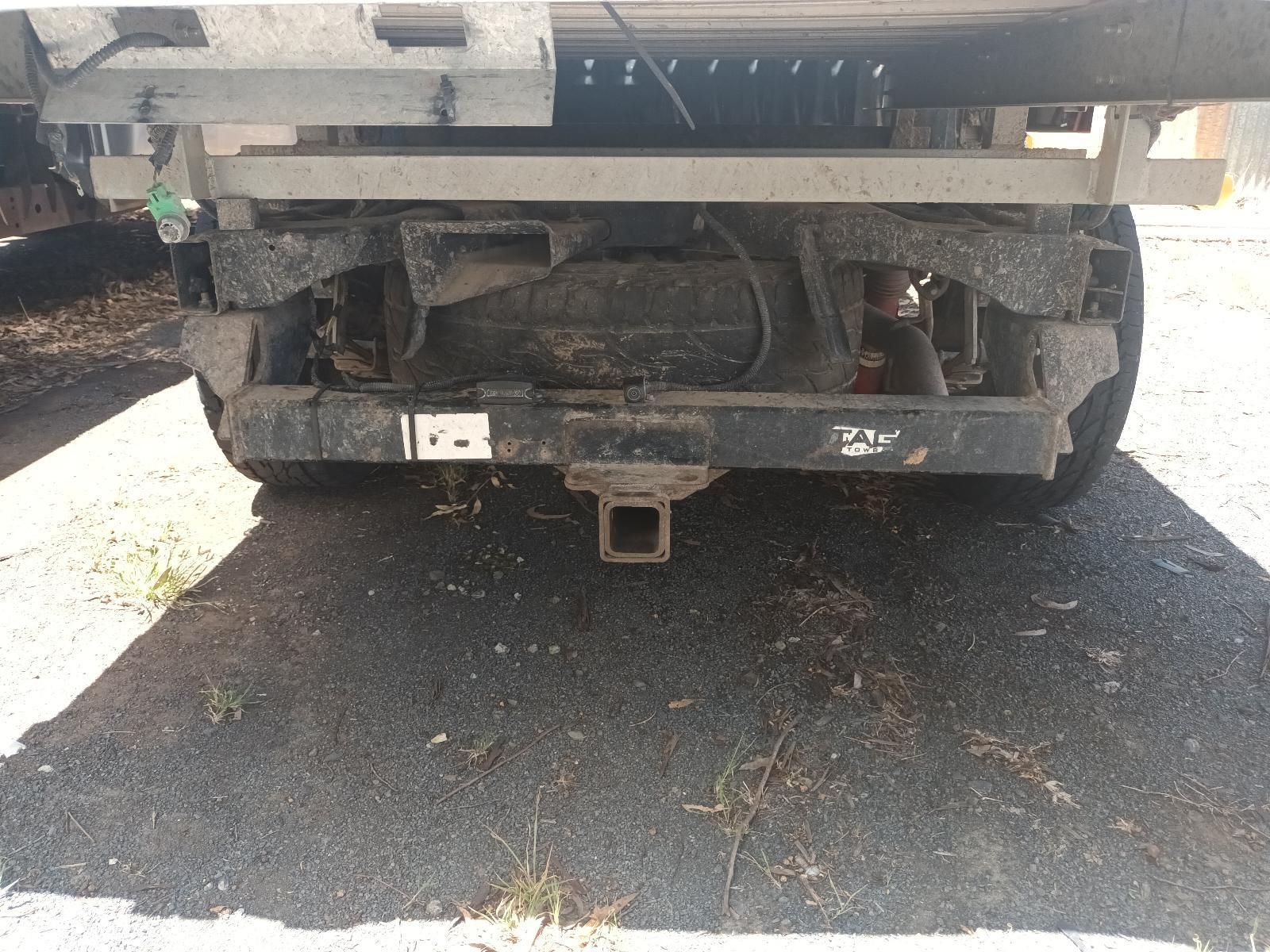 The Back of a Truck with a Trailer Attached to It is Parked in a Parking Lot — South West 4WD Wreckers in Harristown, QLD