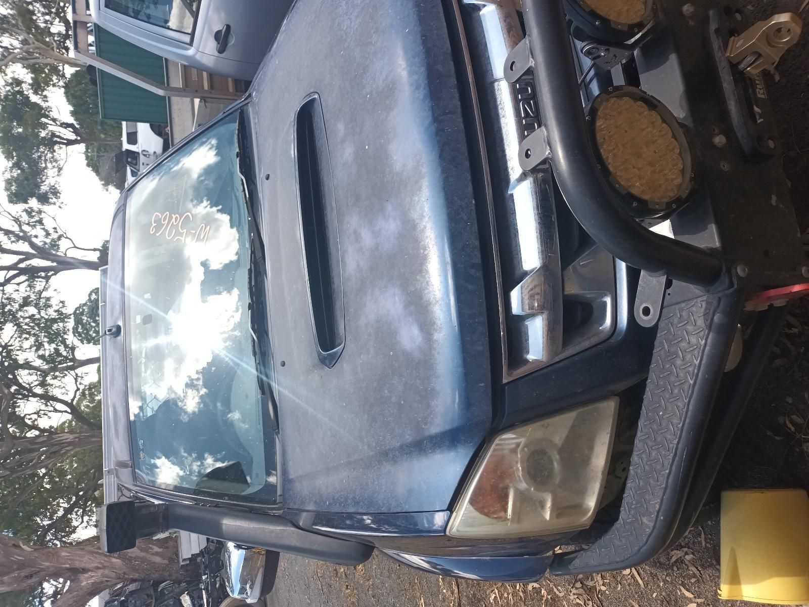 A Blue Truck is Parked in a Parking Lot with Trees in the Background — South West 4WD Wreckers in Harristown, QLD