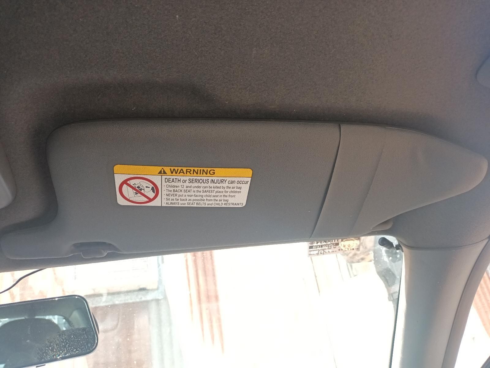 A Car Sun Visor with a Warning Sign on It — South West 4WD Wreckers in Harristown, QLD