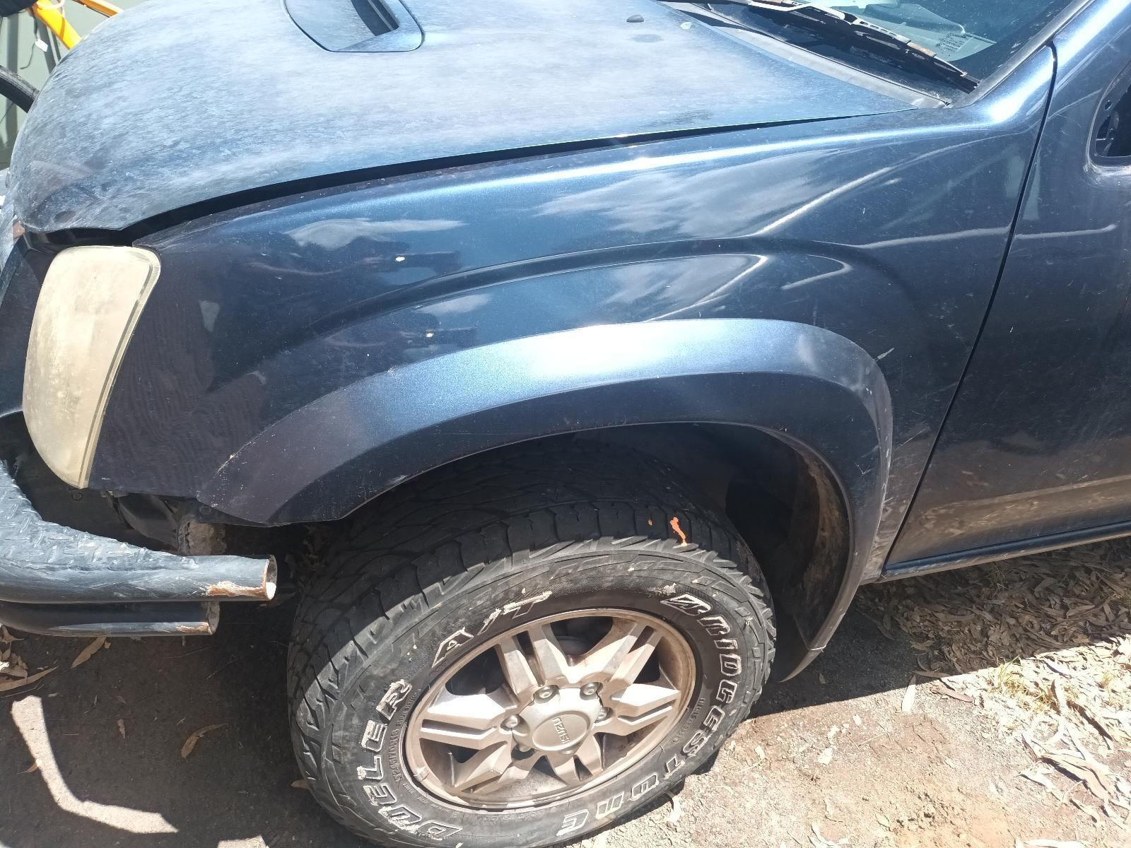 A Blue Truck with a Broken Hood is Parked on the Side of the Road — South West 4WD Wreckers in Harristown, QLD