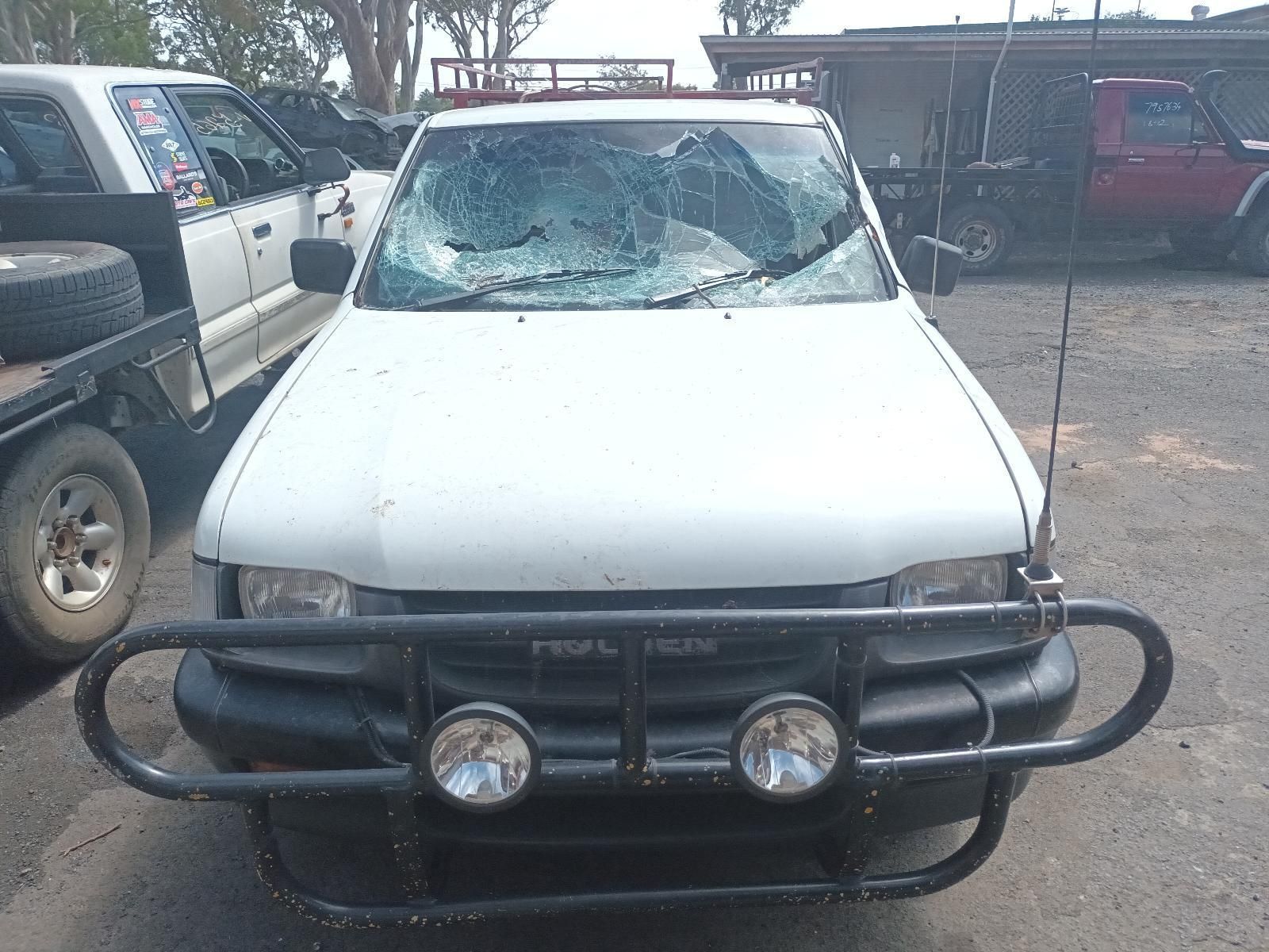 A White Truck with a Broken Windshield is Parked in a Parking Lot — South West 4WD Wreckers in Harristown, QLD