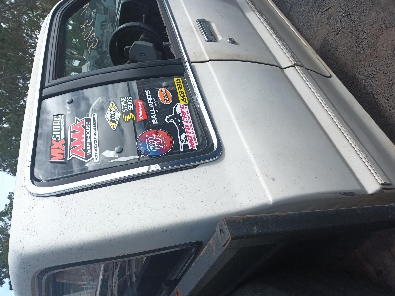 A White Truck with Many Stickers on It — South West 4WD Wreckers In Brisbane, QLD