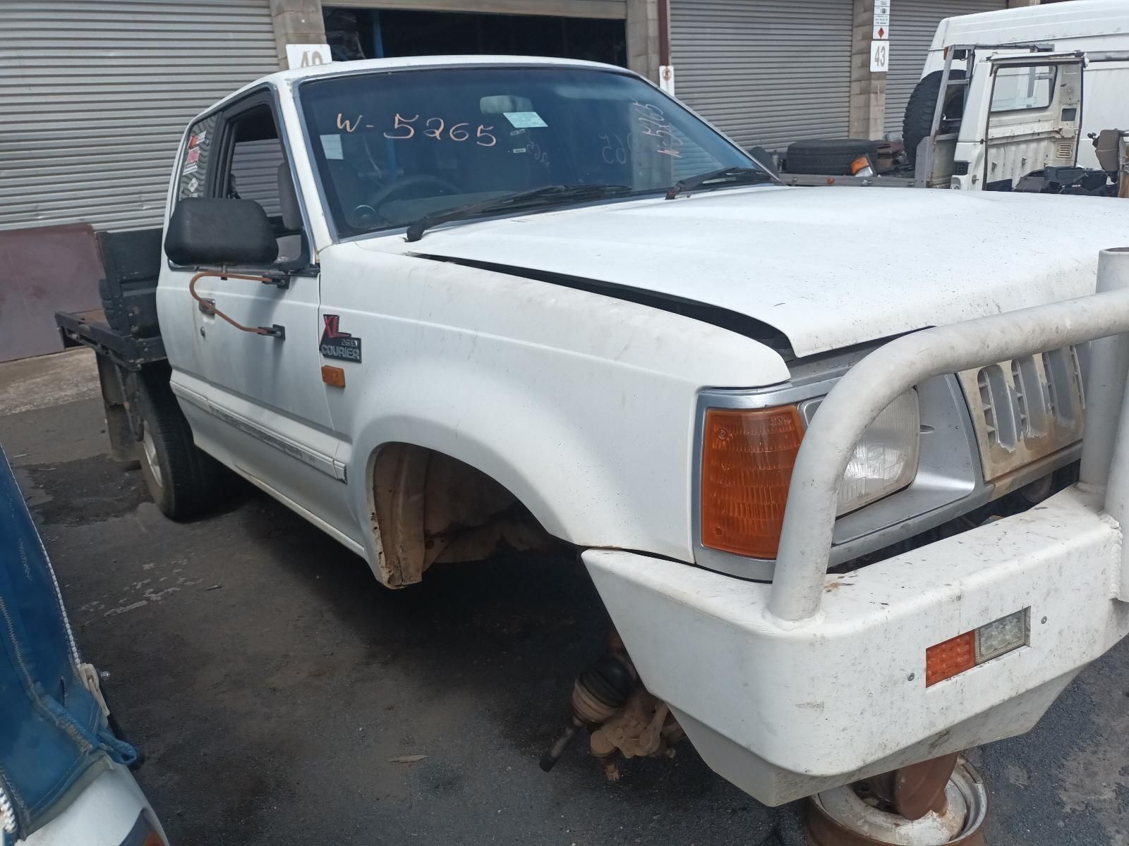 A White Truck is Sitting on the Side of the Road — South West 4WD Wreckers In Brisbane, QLD