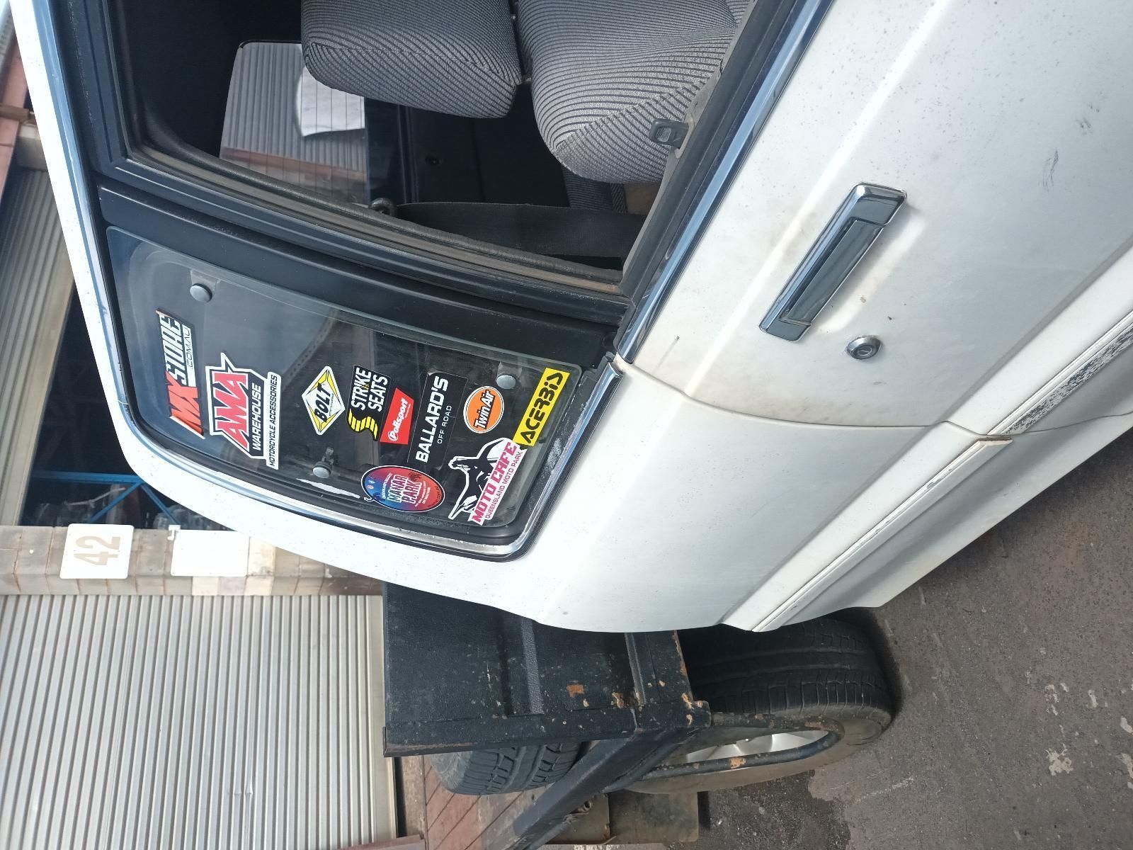 A White Car with a Lot of Stickers on It — South West 4WD Wreckers In Brisbane, QLD