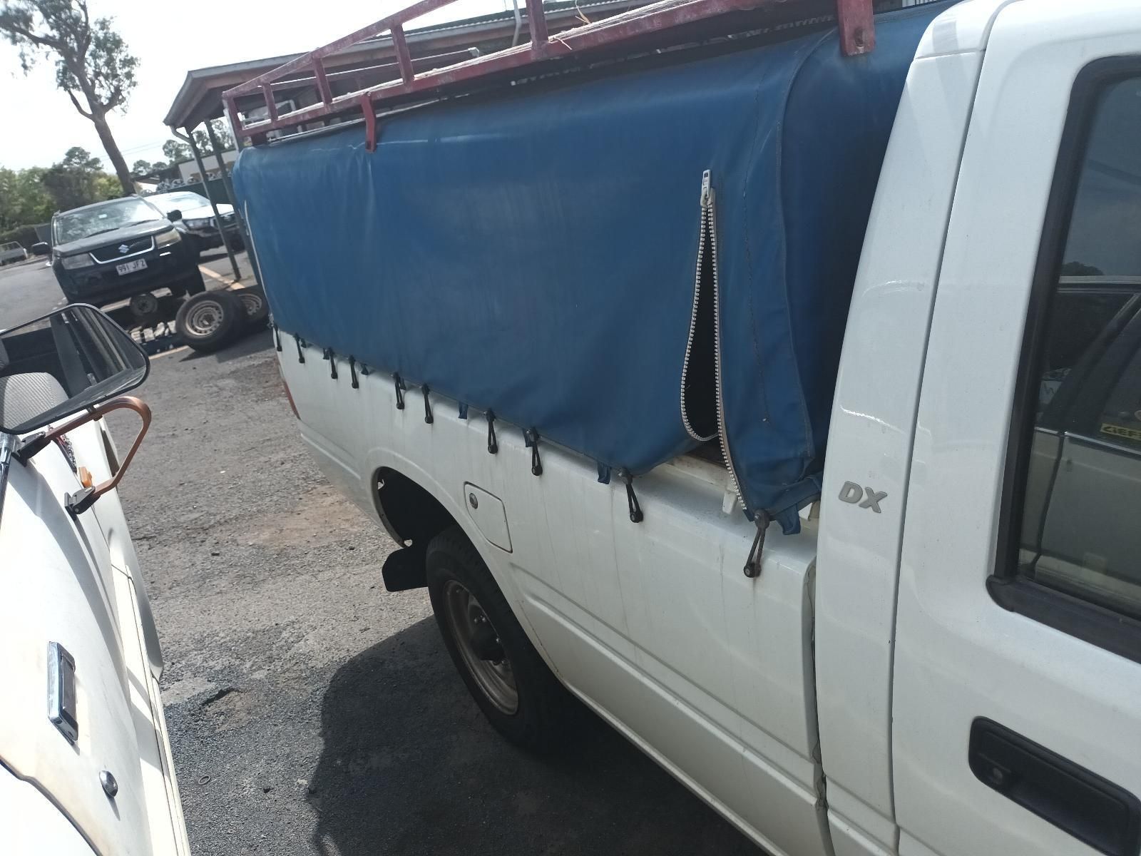 A White Truck with a Blue Tarp on the Back of It — South West 4WD Wreckers In Brisbane, QLD