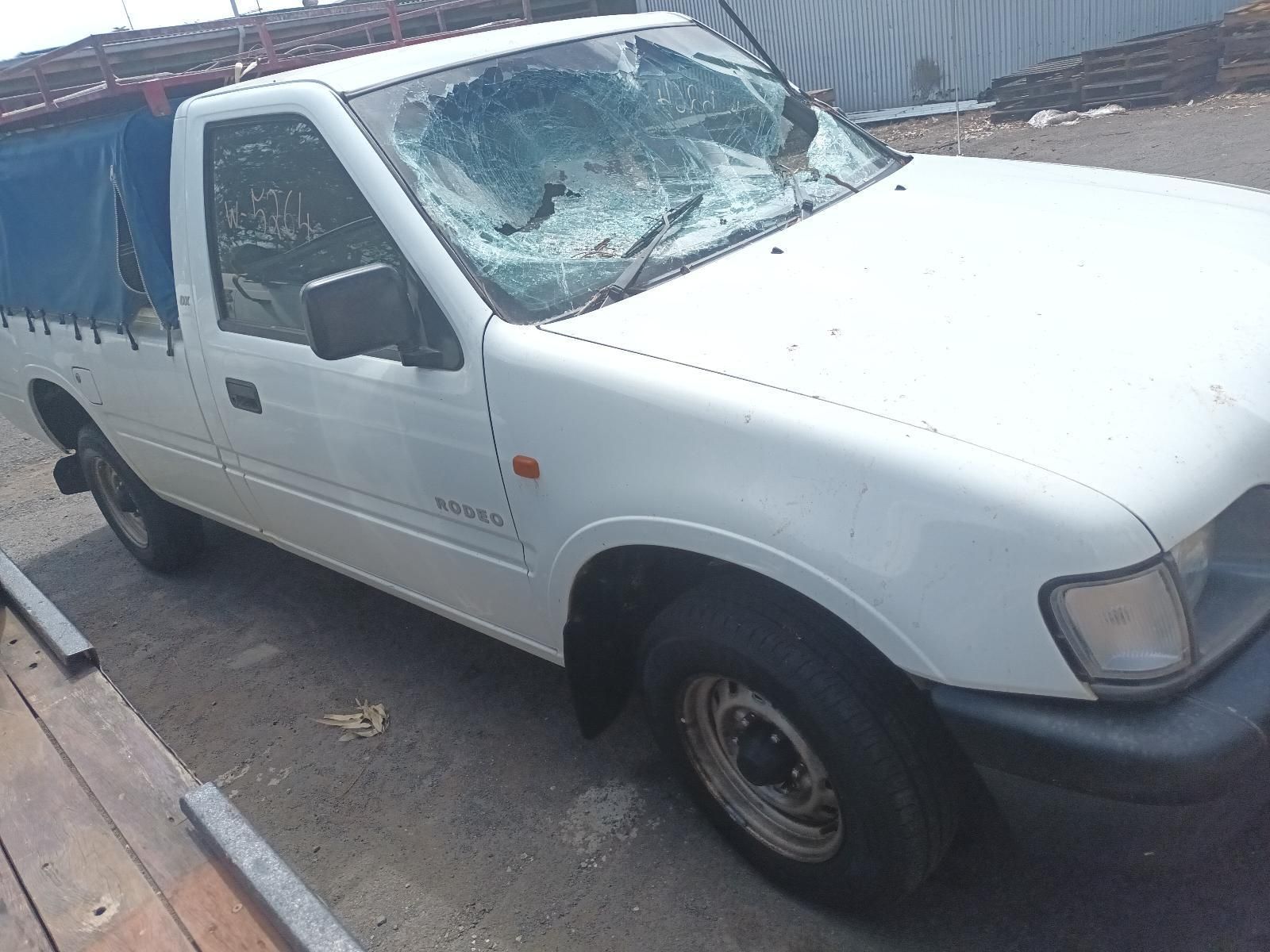A White Truck with a Broken Windshield is Parked in a Parking Lot — South West 4WD Wreckers In Brisbane, QLD