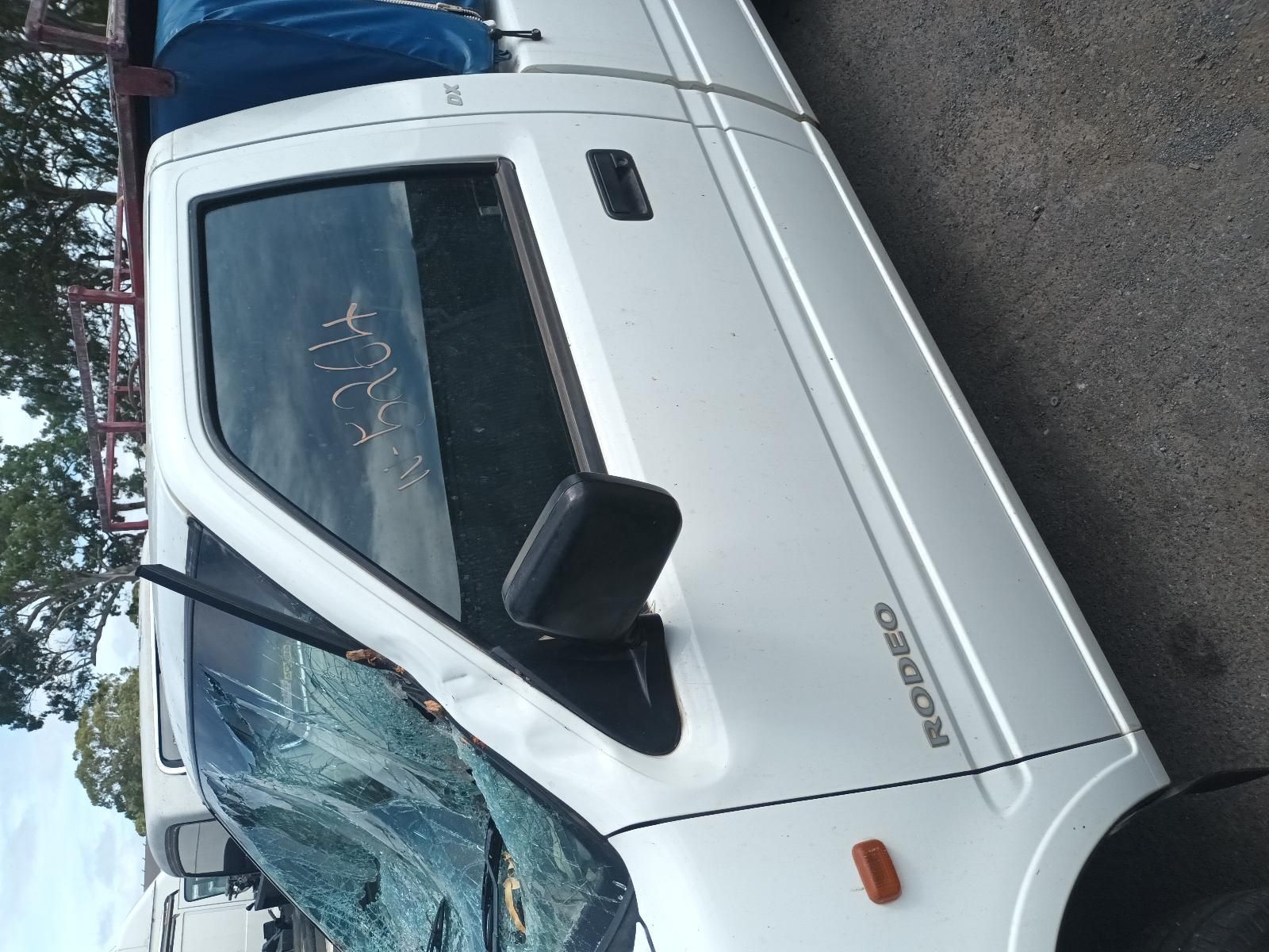 A White Rodeo Truck is Parked on the Side of the Road — South West 4WD Wreckers In Brisbane, QLD