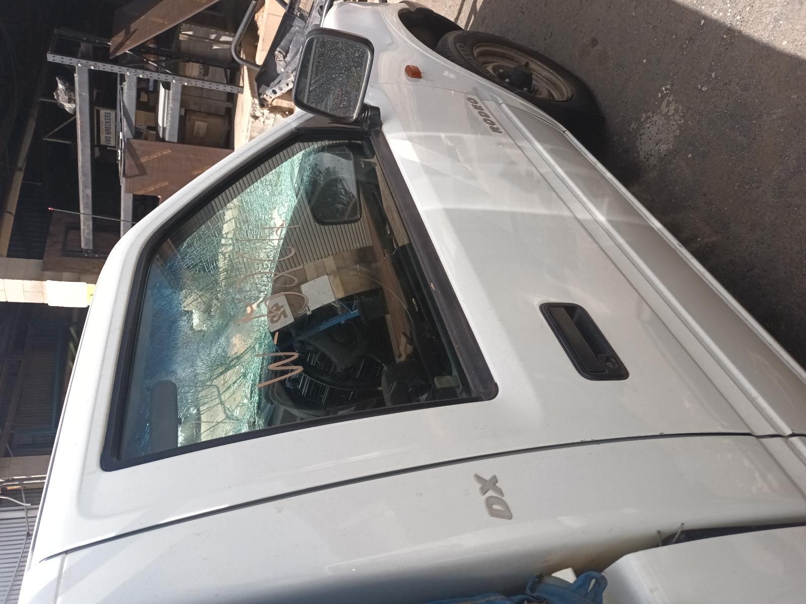 A White Truck with a Broken Windshield is Parked on the Side of the Road — South West 4WD Wreckers In Brisbane, QLD 