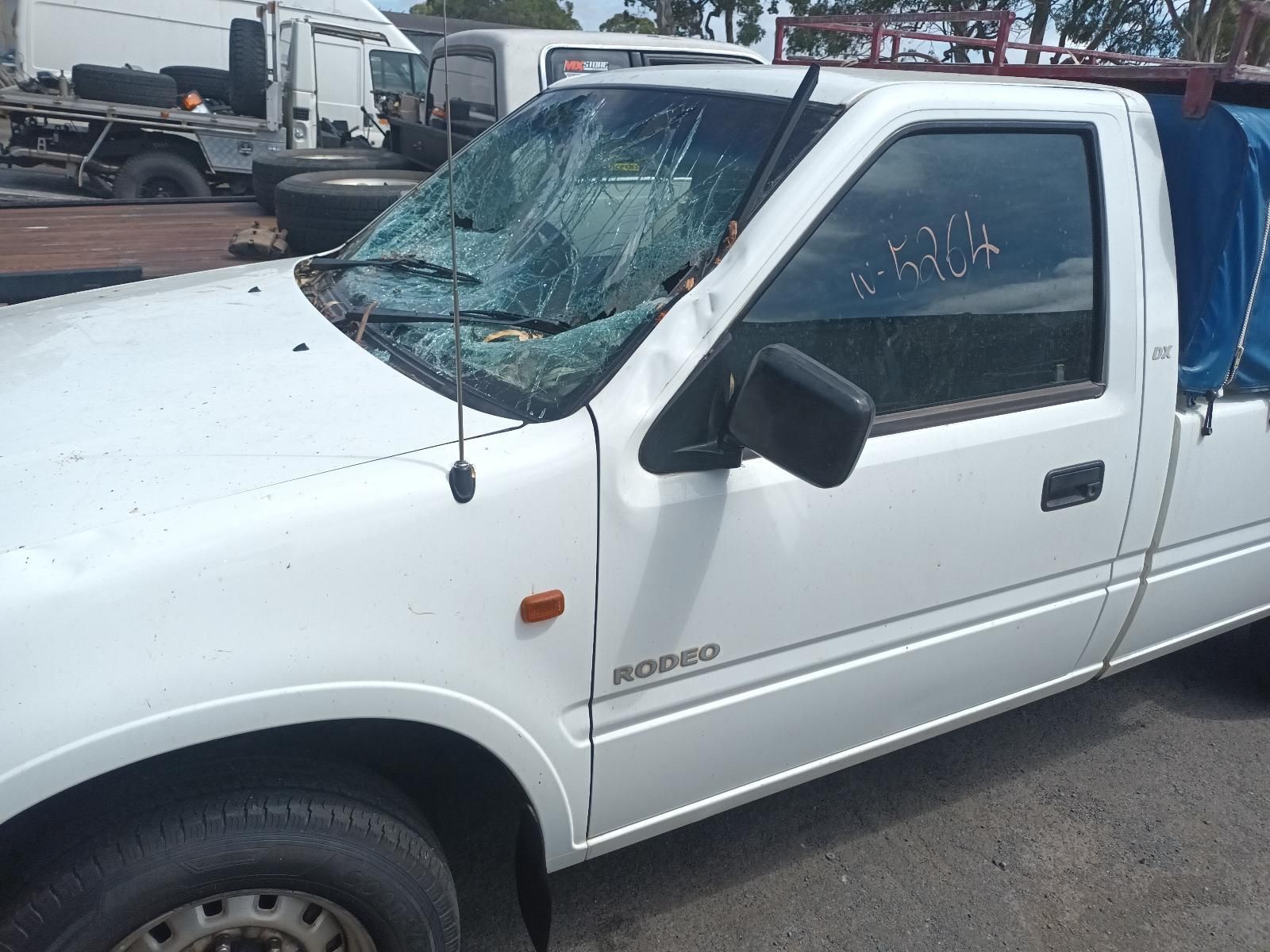 A White Truck with a Broken Windshield is Parked on the Side of the Road — South West 4WD Wreckers In Brisbane, QLD