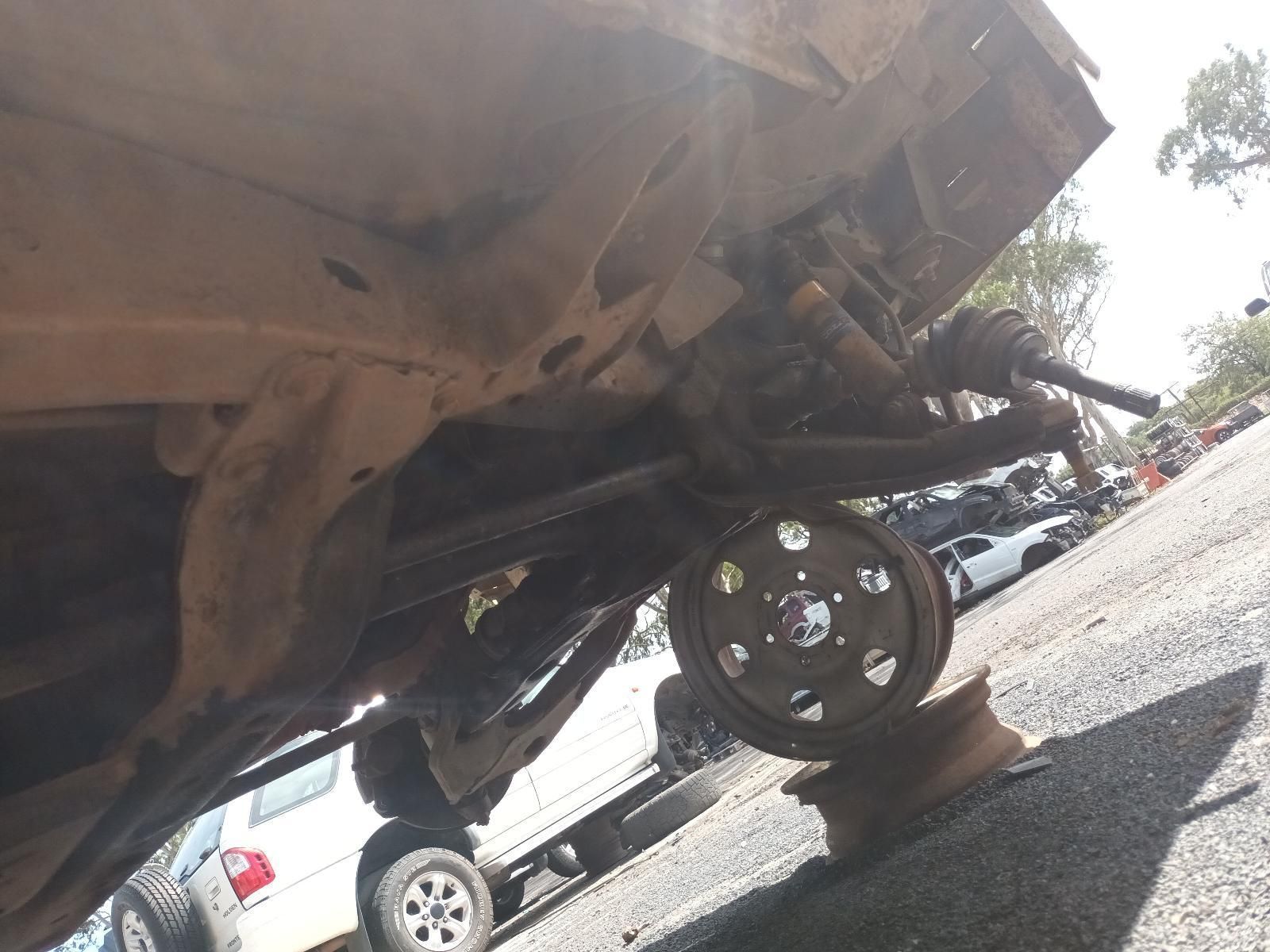 The Underside of a Car is Shown with a Wheel on a Jack — South West 4WD Wreckers In Brisbane, QLD