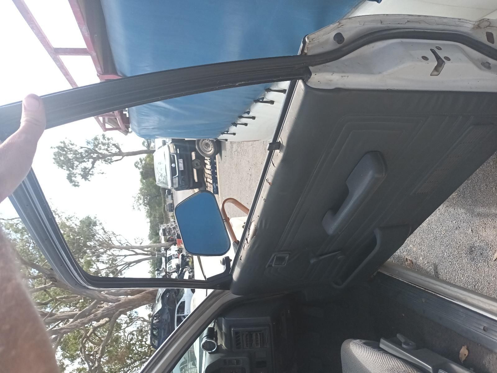 A Person is Opening the Door of a White Car — South West 4WD Wreckers In Brisbane, QLD