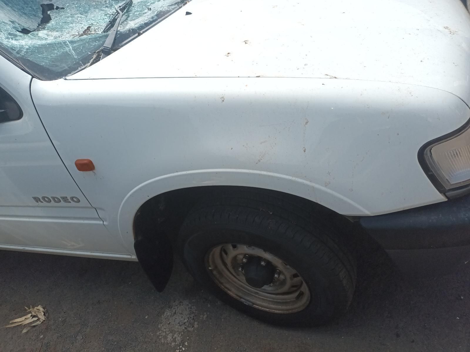 A White Van with a Broken Windshield is Parked on the Side of the Road — South West 4WD Wreckers In Brisbane, QLD